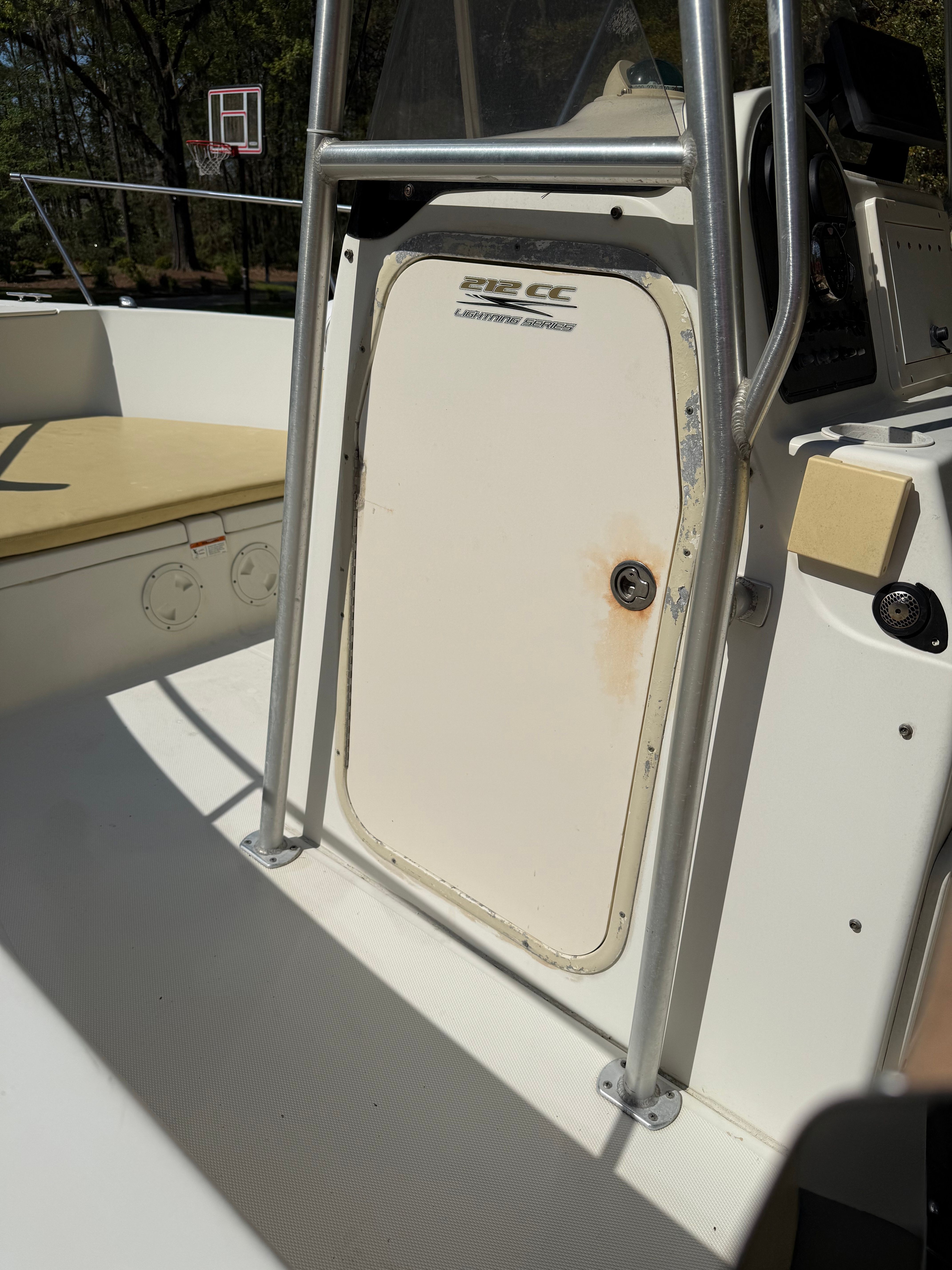 Close-up of a boat console with a white door and metal frame.