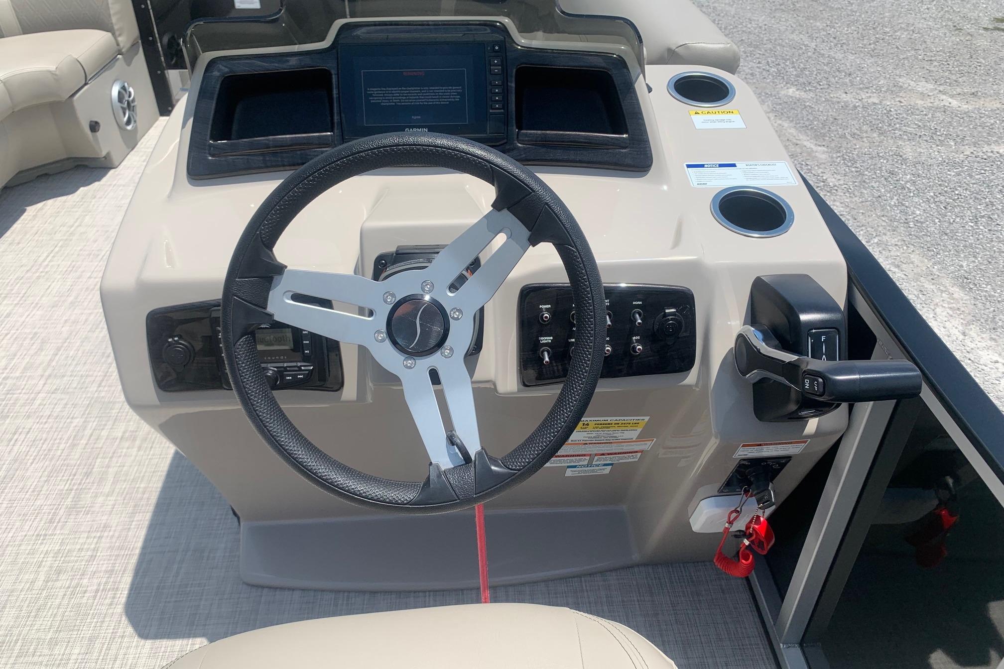 2023 Silver Wave 2410 SW3 CLS boat dashboard with steering wheel and controls.