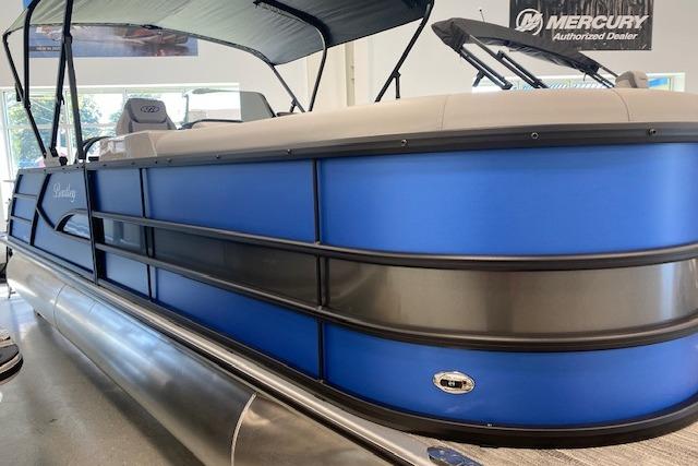 2026 Bentley Pontoons Legacy 223 Swingback in showroom, featuring sleek blue design.