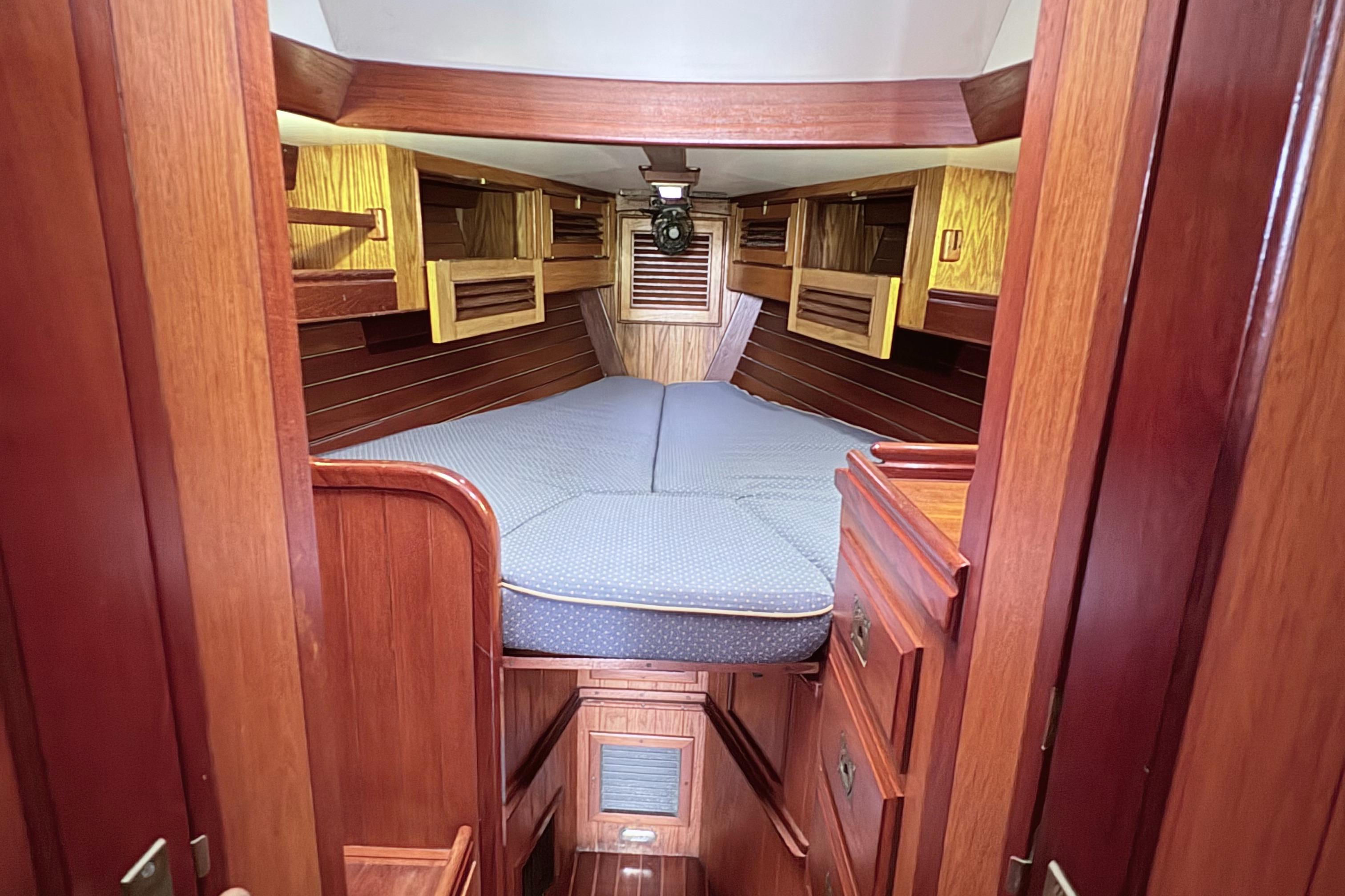 Interior of 1984 Shannon Aegean 51 sailboat with wooden finish and cozy sleeping area.