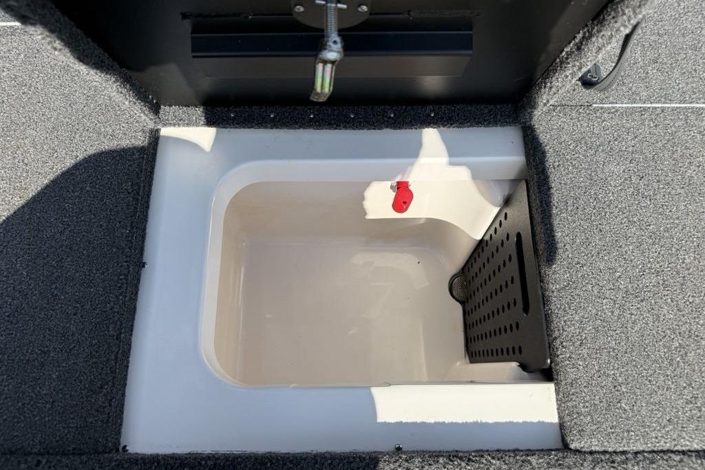2023 Vexus AVX189 boat storage compartment with carpeted interior and drainage system.