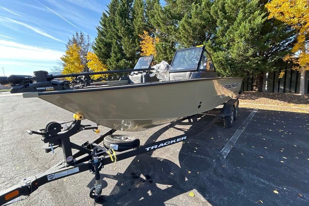 2026 Tracker Targa V-19 Combo boat on trailer, parked near autumn trees.