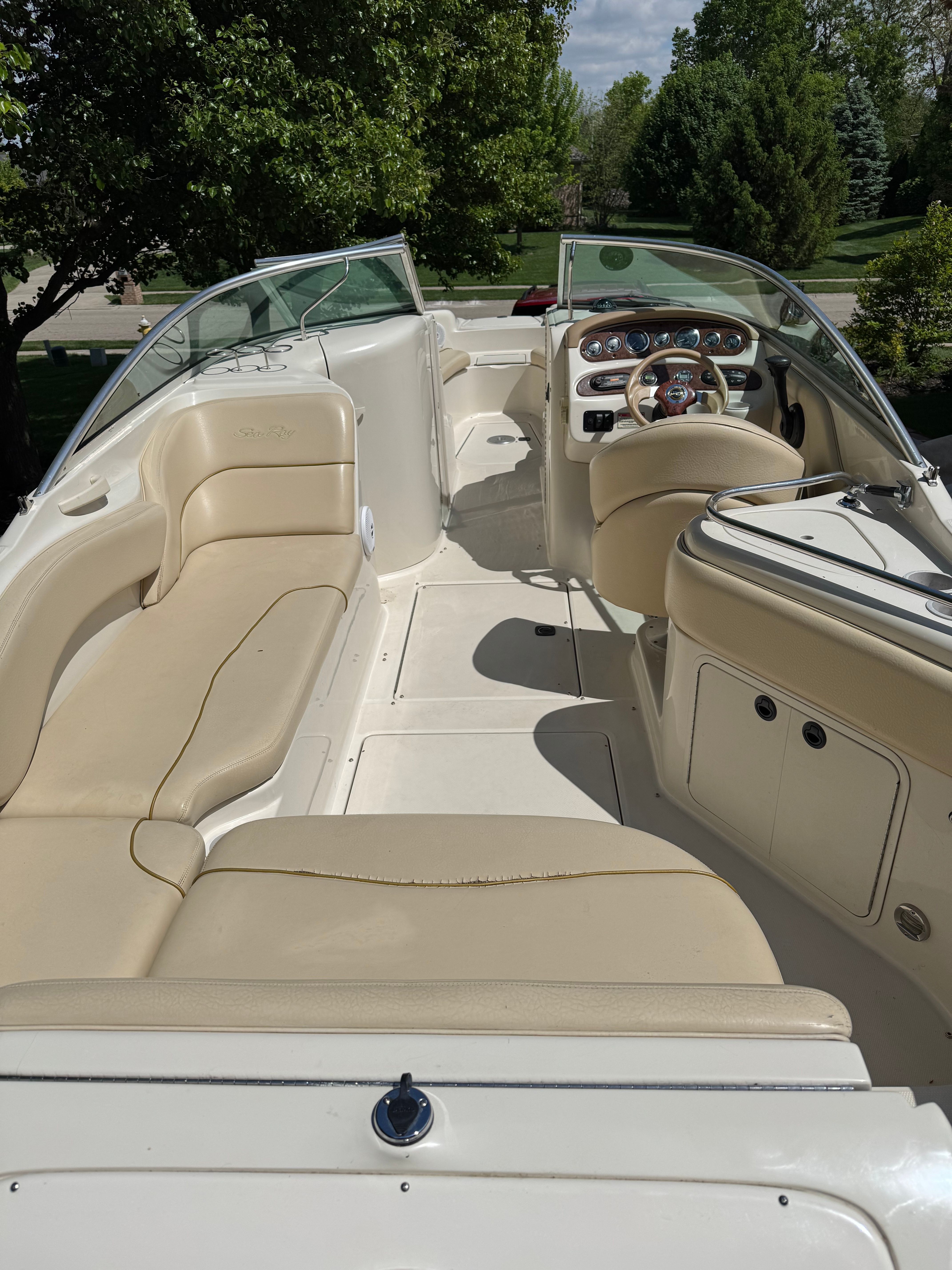 Interior of a 2001 Sea Ray 240 Sundeck boat with beige seating.