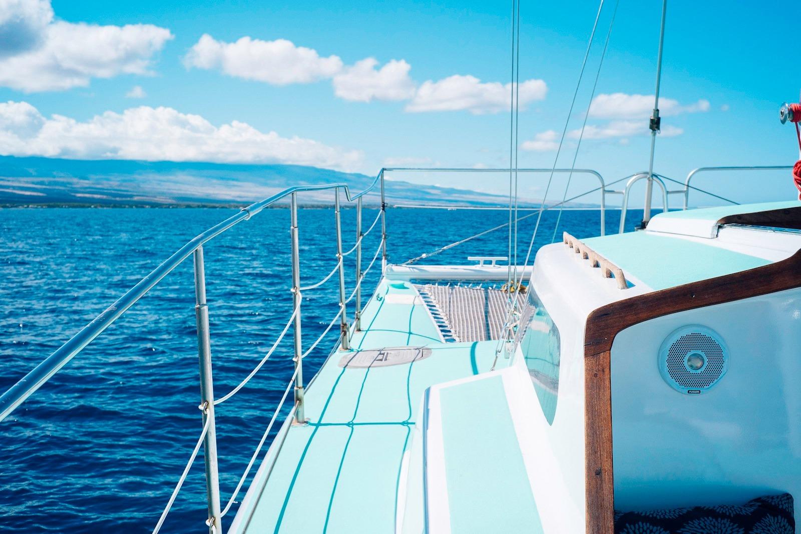 1978 CSK Beach Cat sailboat on open ocean under clear blue sky.