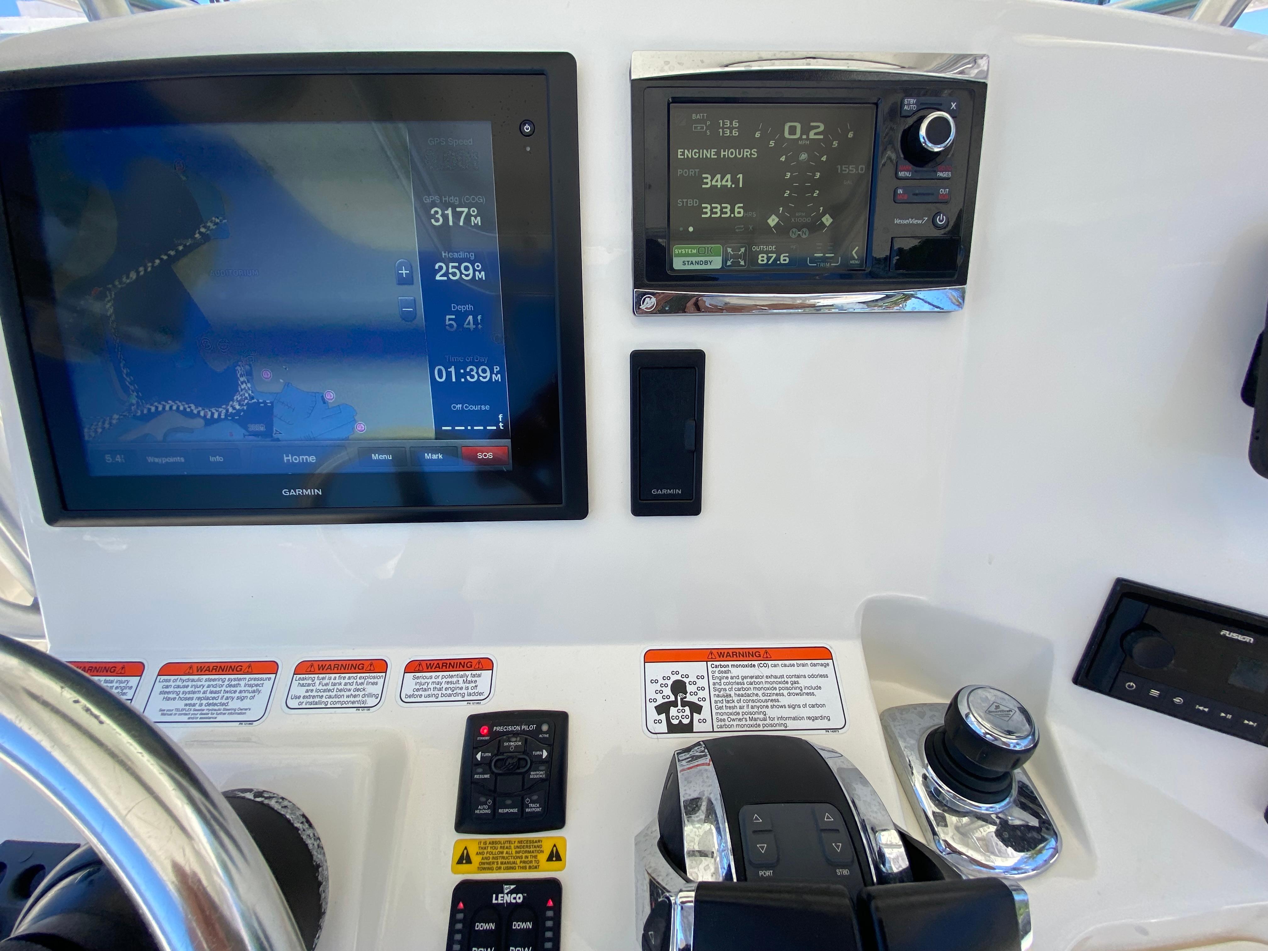 Control panel of a 2014 Mako 284 CC boat with navigation displays.