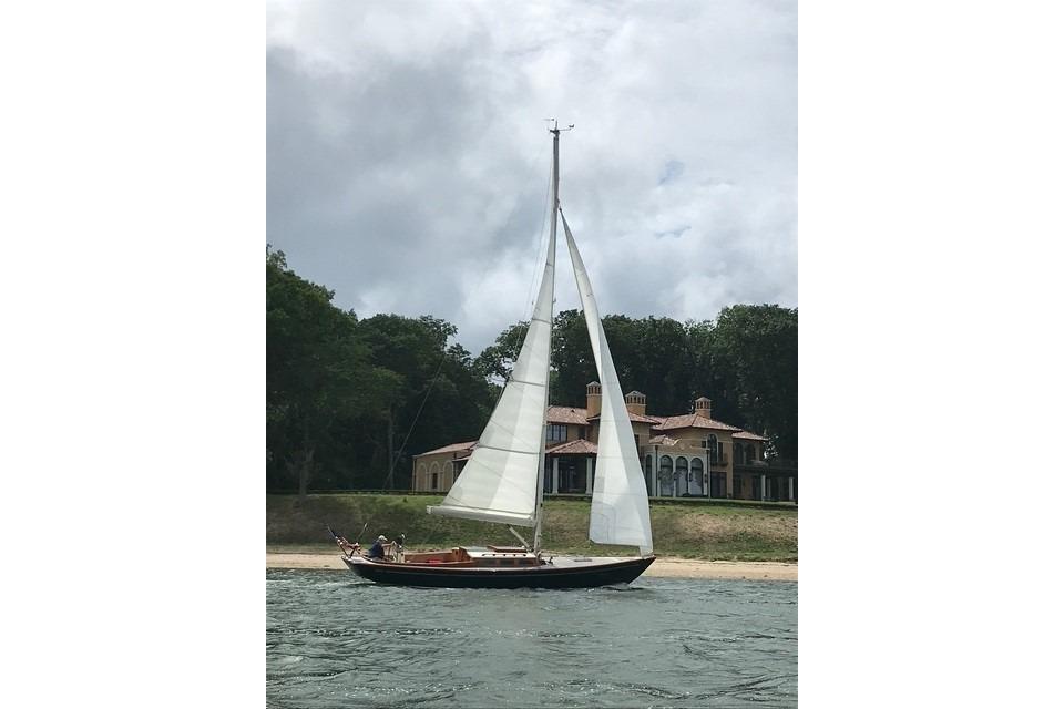 Sailboat on water near a large house, Morris 36 model, 2006.