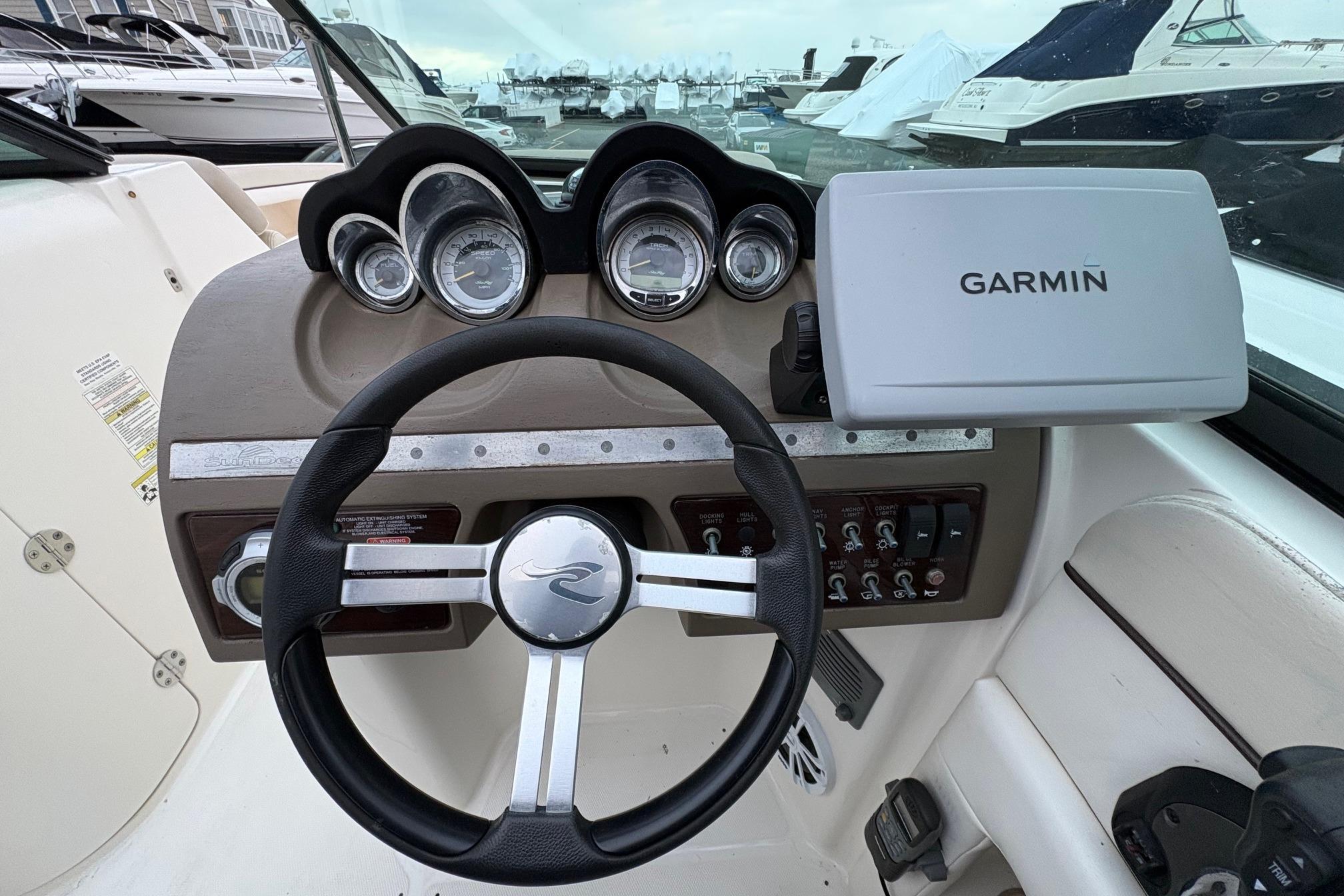 2013 Sea Ray 280 Sundeck dashboard with Garmin navigation system and steering wheel.