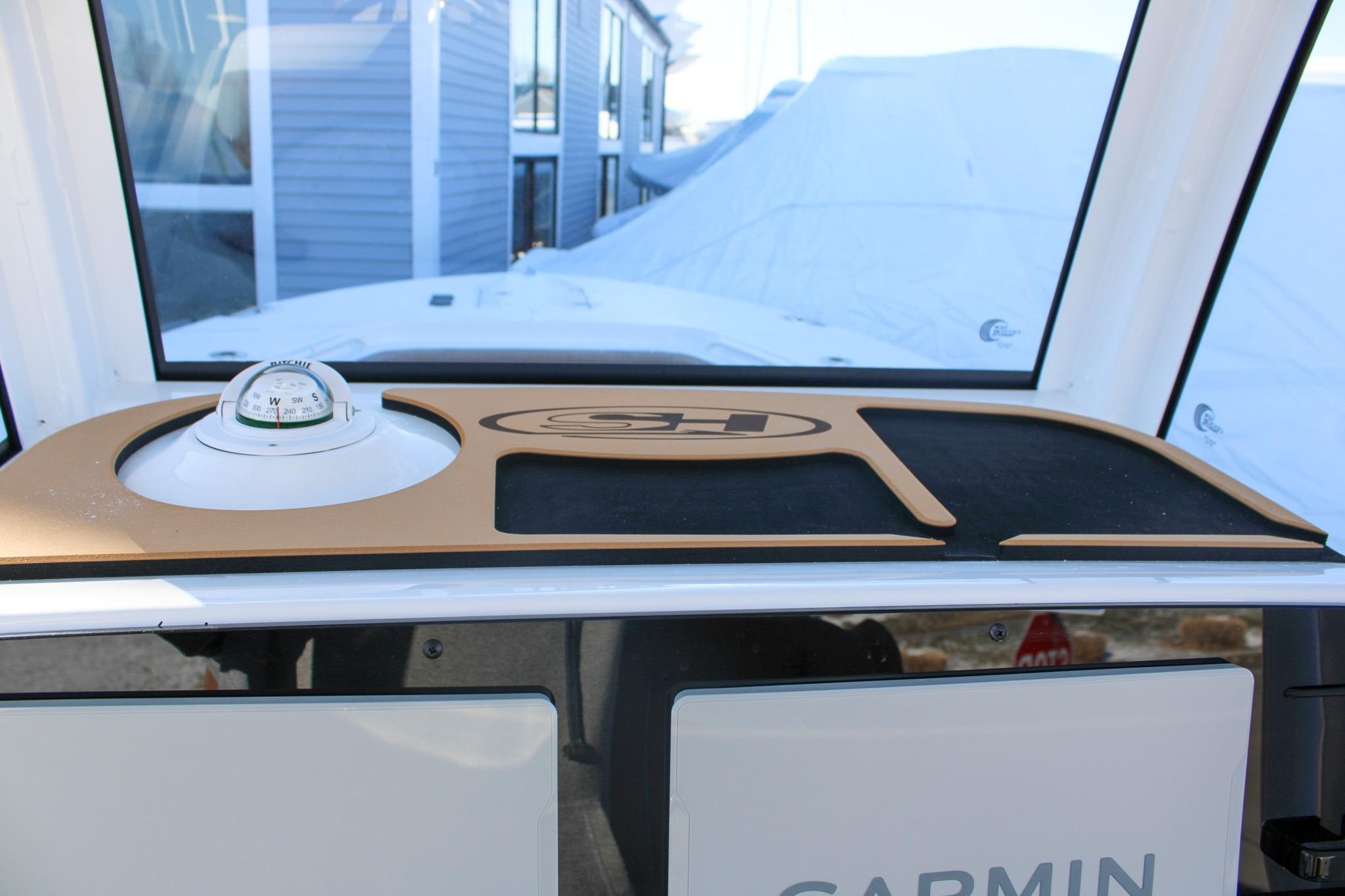 2026 Sea Hunt Gamefish 25 dashboard with compass and Garmin equipment.