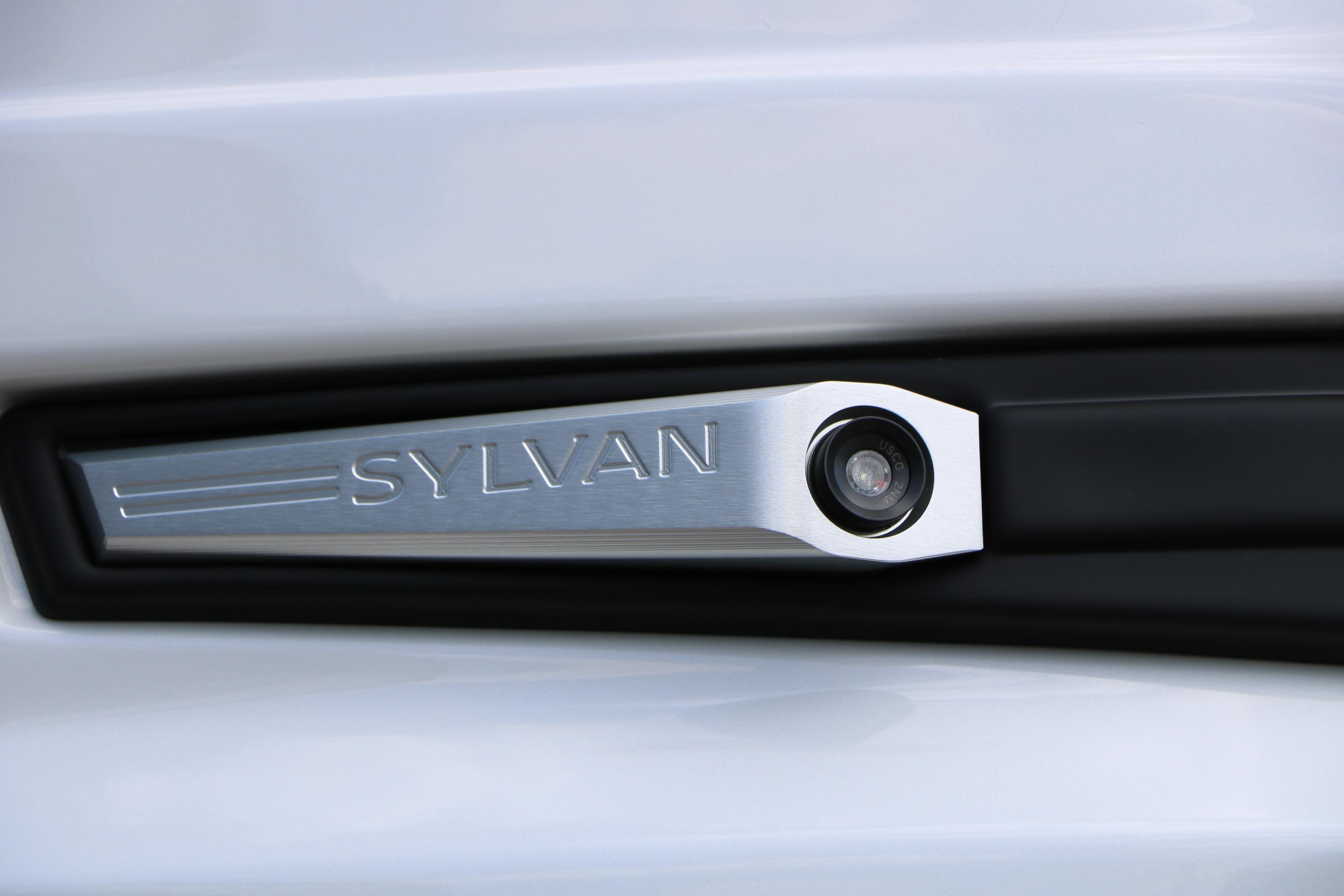 Close-up of 2026 Sylvan L3 DLZ Bar Platinum Edition Tri-Toon logo on sleek surface.