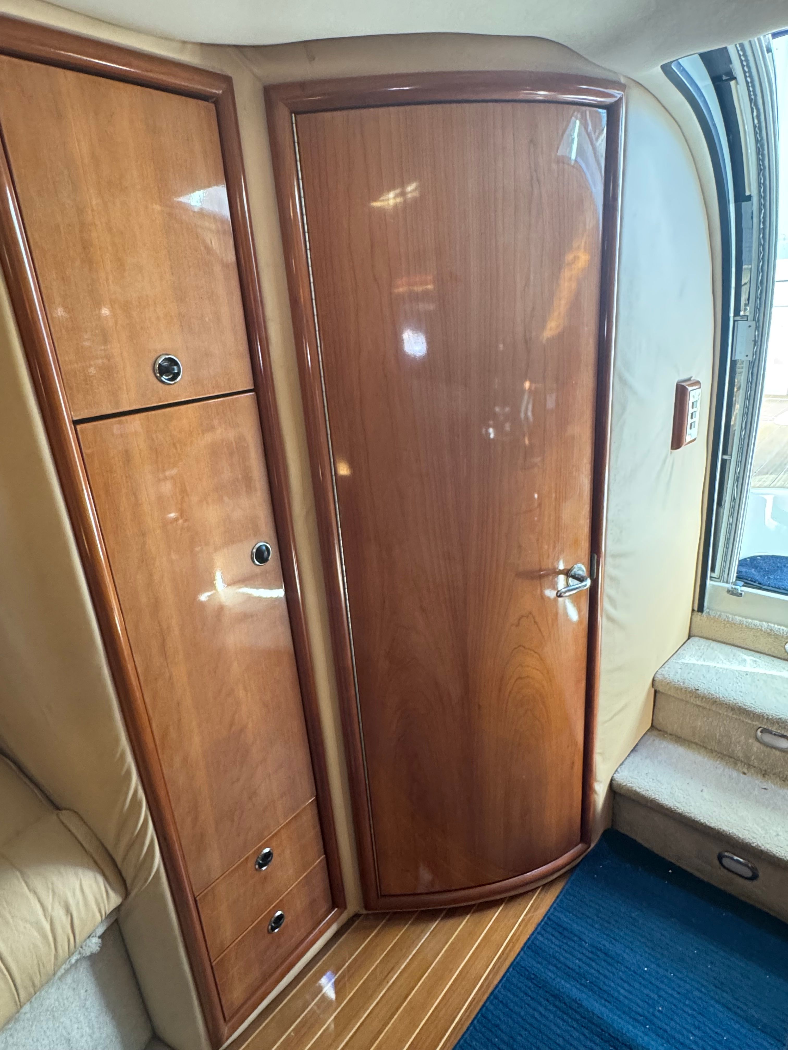 Interior of a 2003 Cobalt 360 with wooden doors and stairs.