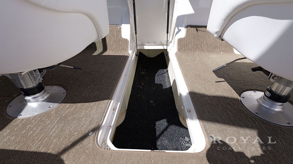 Interior of a 2014 Sea Ray SLX 230 with carpeted floor and two white seats.
