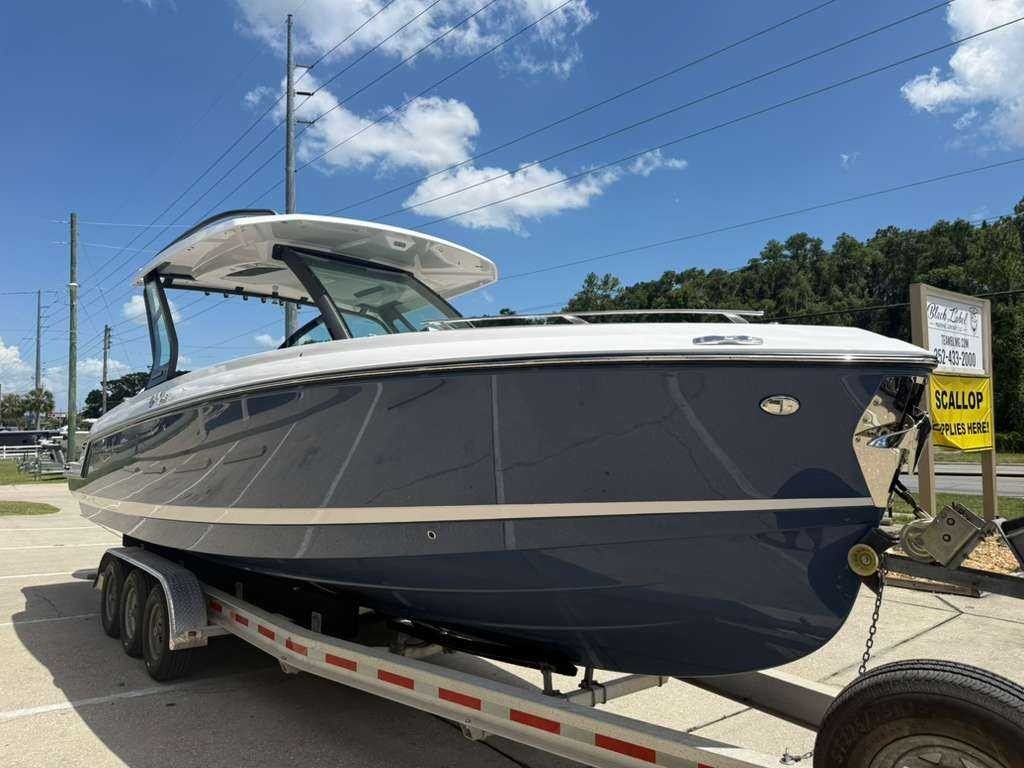 A 2026 Monterey Elite 30 OB boat on a trailer under a blue sky.