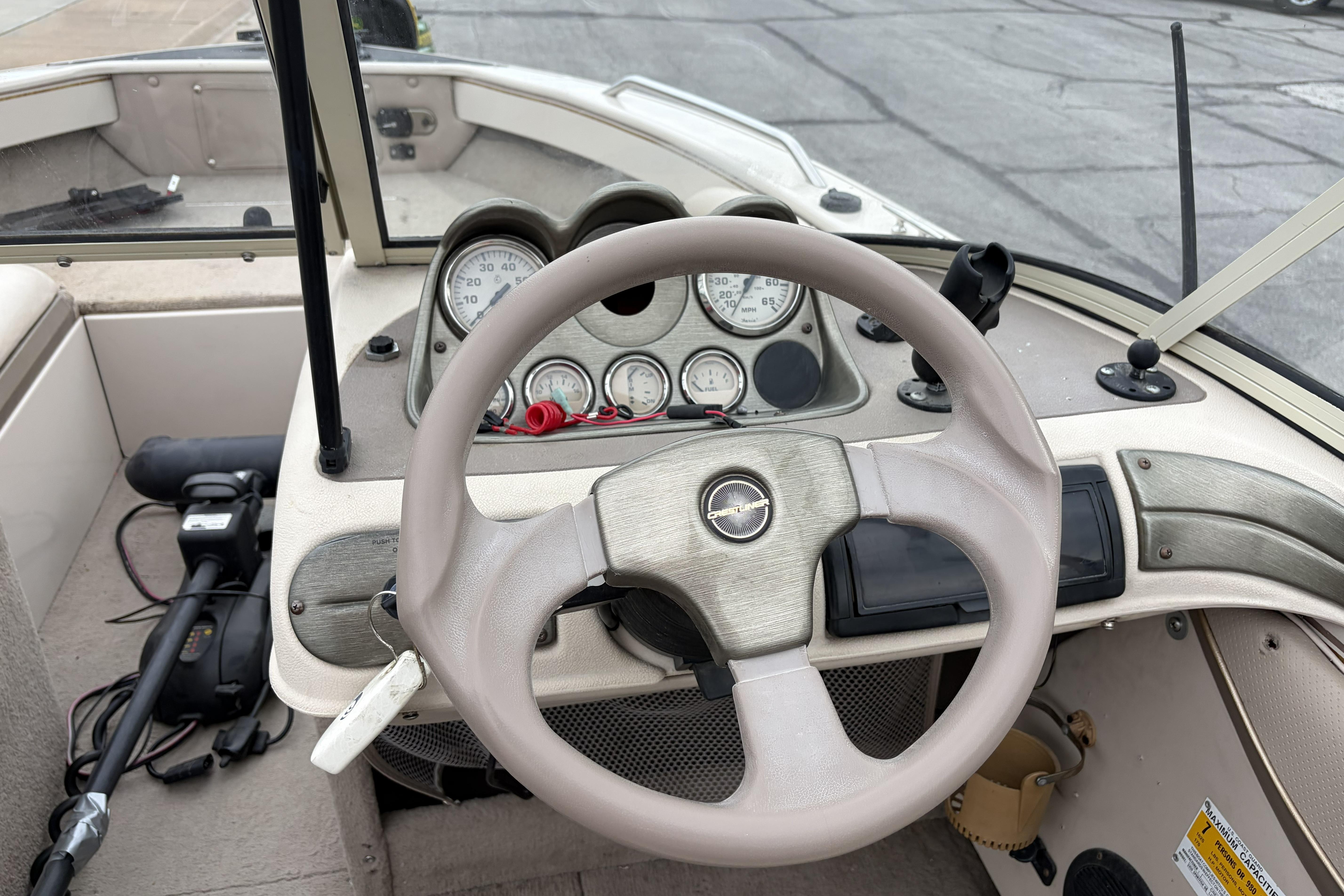 2002 Crestliner 1850 Sportfish boat dashboard with steering wheel and instrument panel.