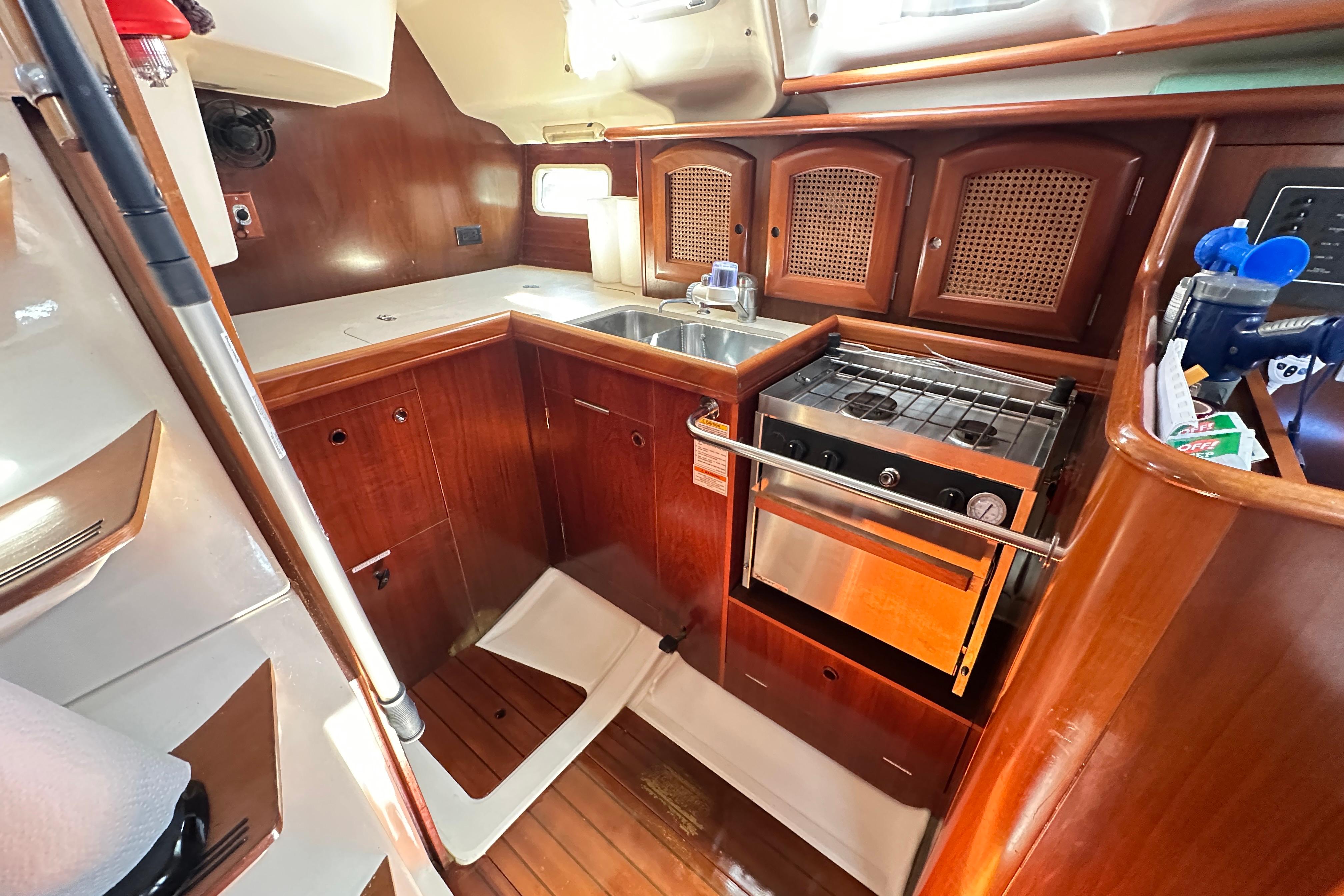 1999 Beneteau Oceanis 352 yacht kitchen with wood cabinetry and stainless steel appliances.
