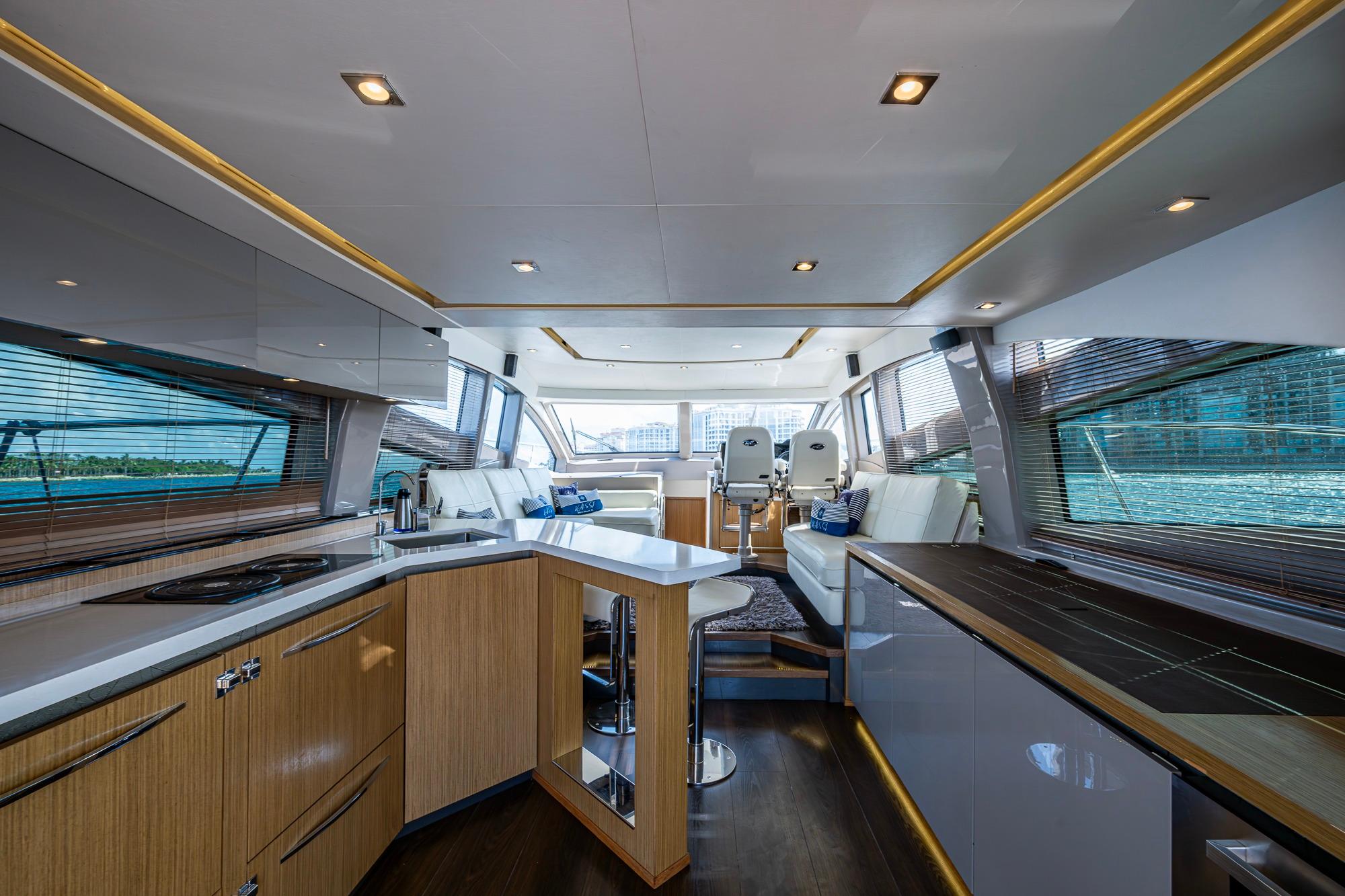 Luxurious interior of 2018 Sea Ray L550 Fly yacht with modern kitchen and seating area.