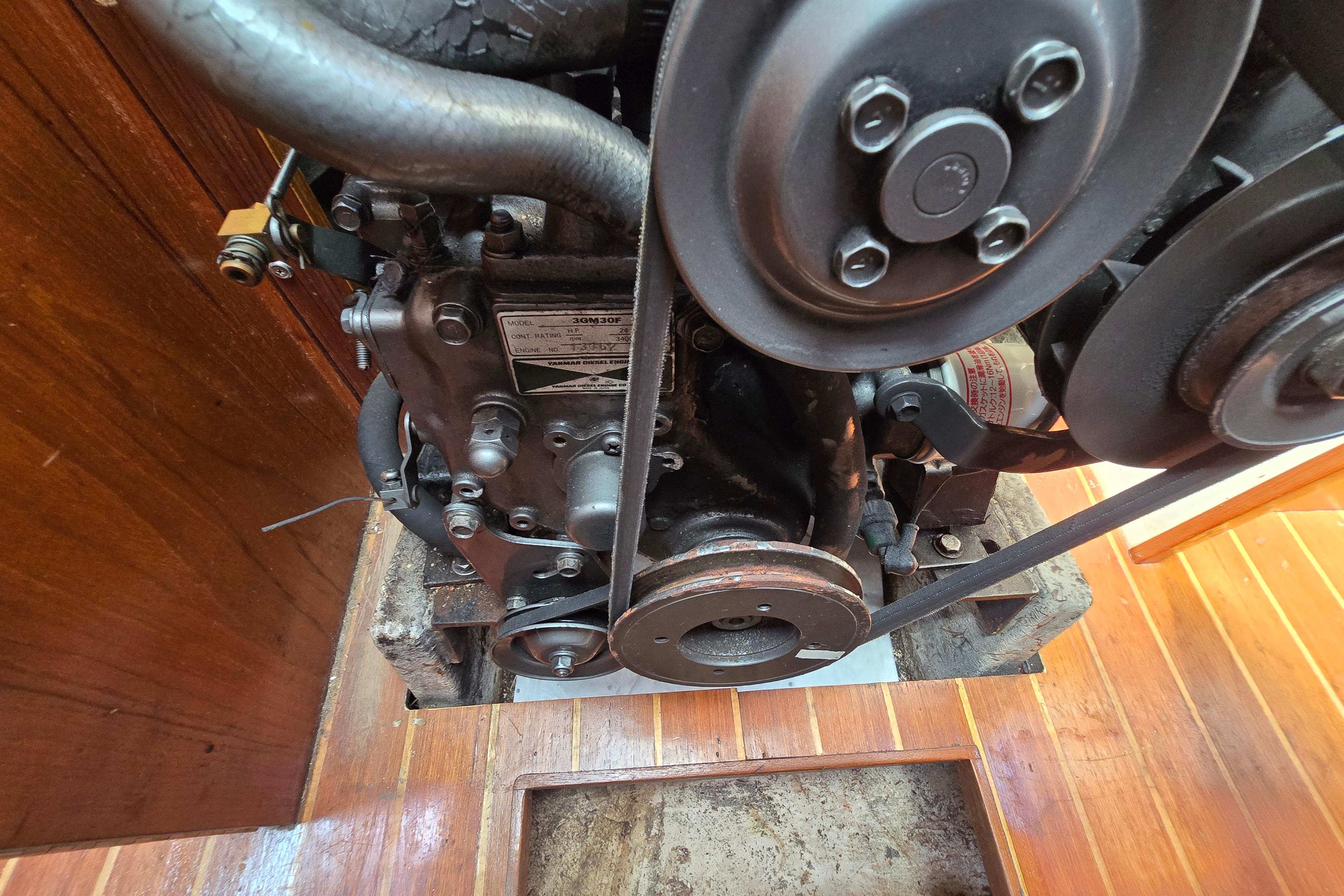 Close-up of a 1993 Caliber 35 engine with visible belts and components.