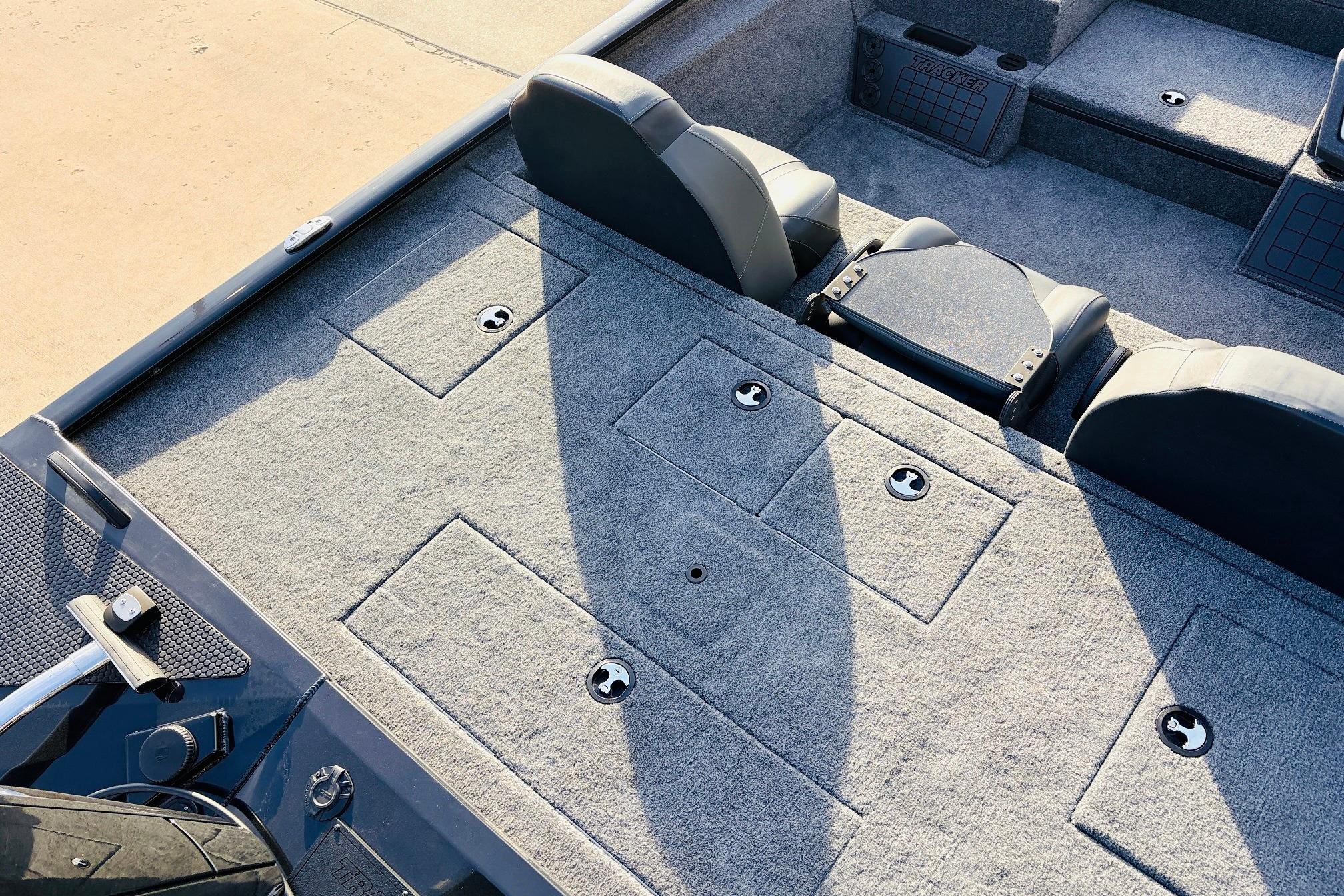 2025 Tracker Savage 215 boat interior with gray carpet and seating arrangement.