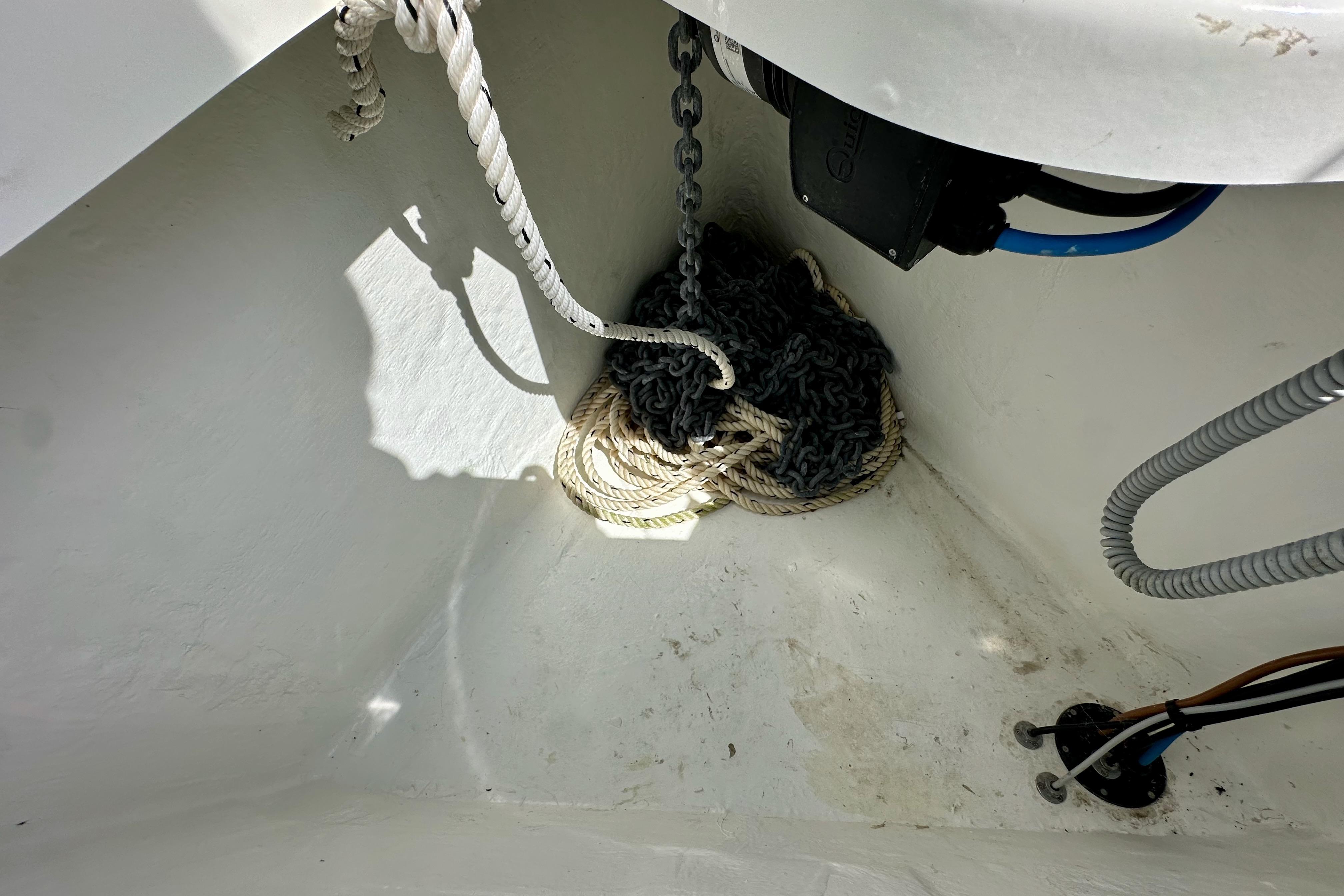 Anchor locker of 2024 Jeanneau Sun Odyssey 410 with ropes and chains.