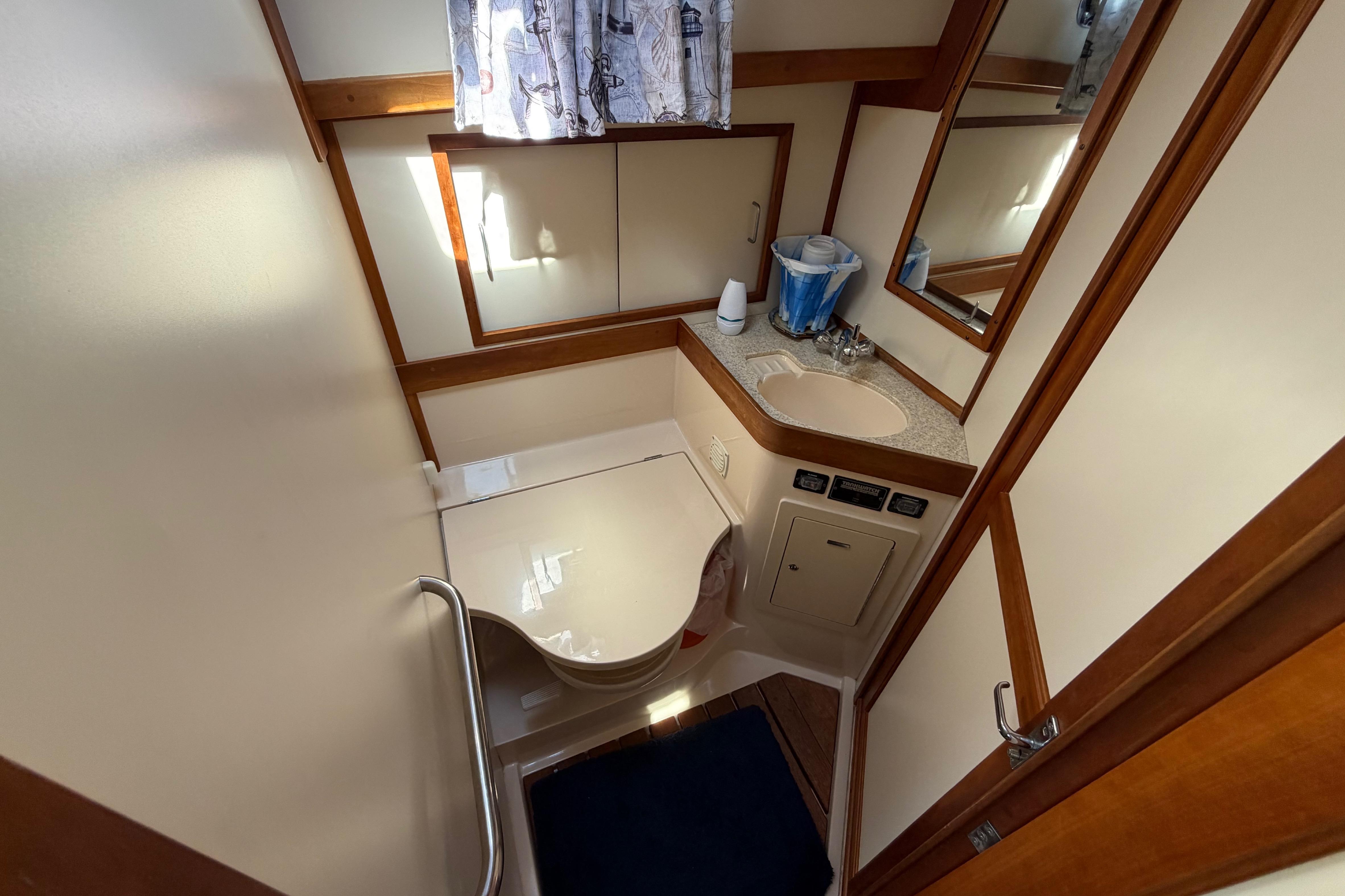 Bathroom interior of 2000 Sabreline 36 Express yacht, featuring sink and toilet.