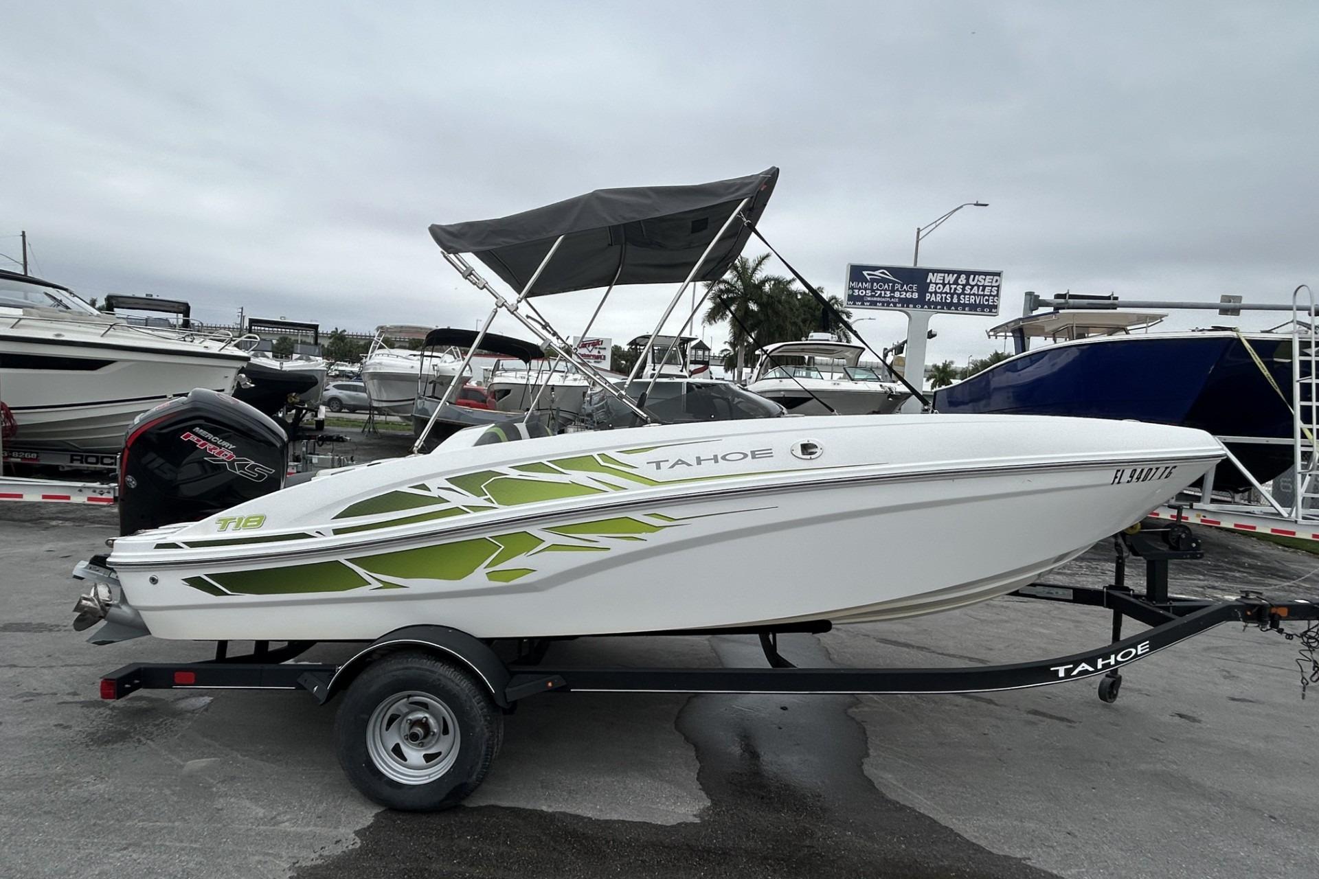 2022 Tahoe T18 boat with canopy on trailer in marina setting.
