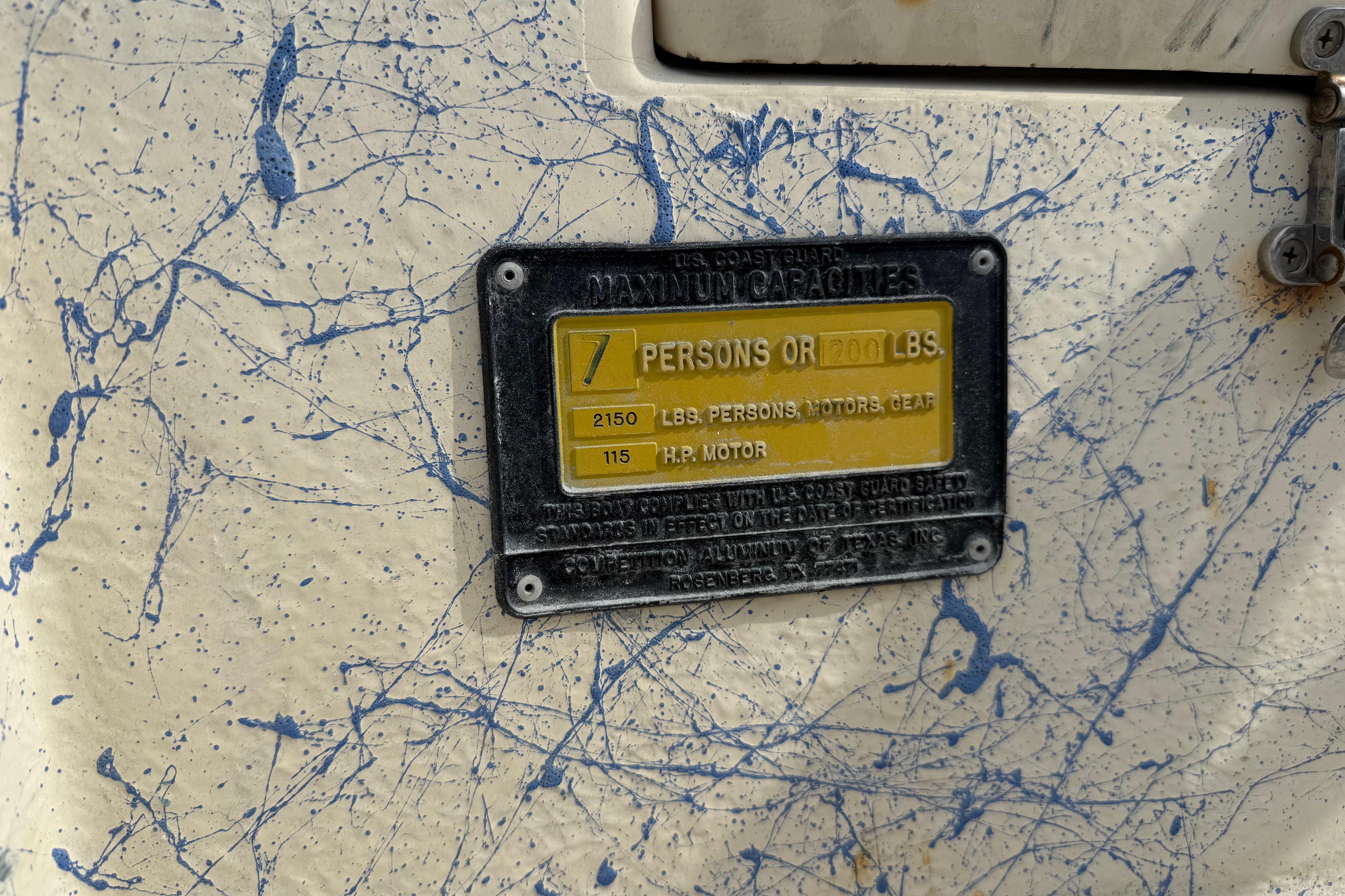 2007 Flats Cat 19 capacity plate, 7 persons or 1200 lbs, blue splatter design.