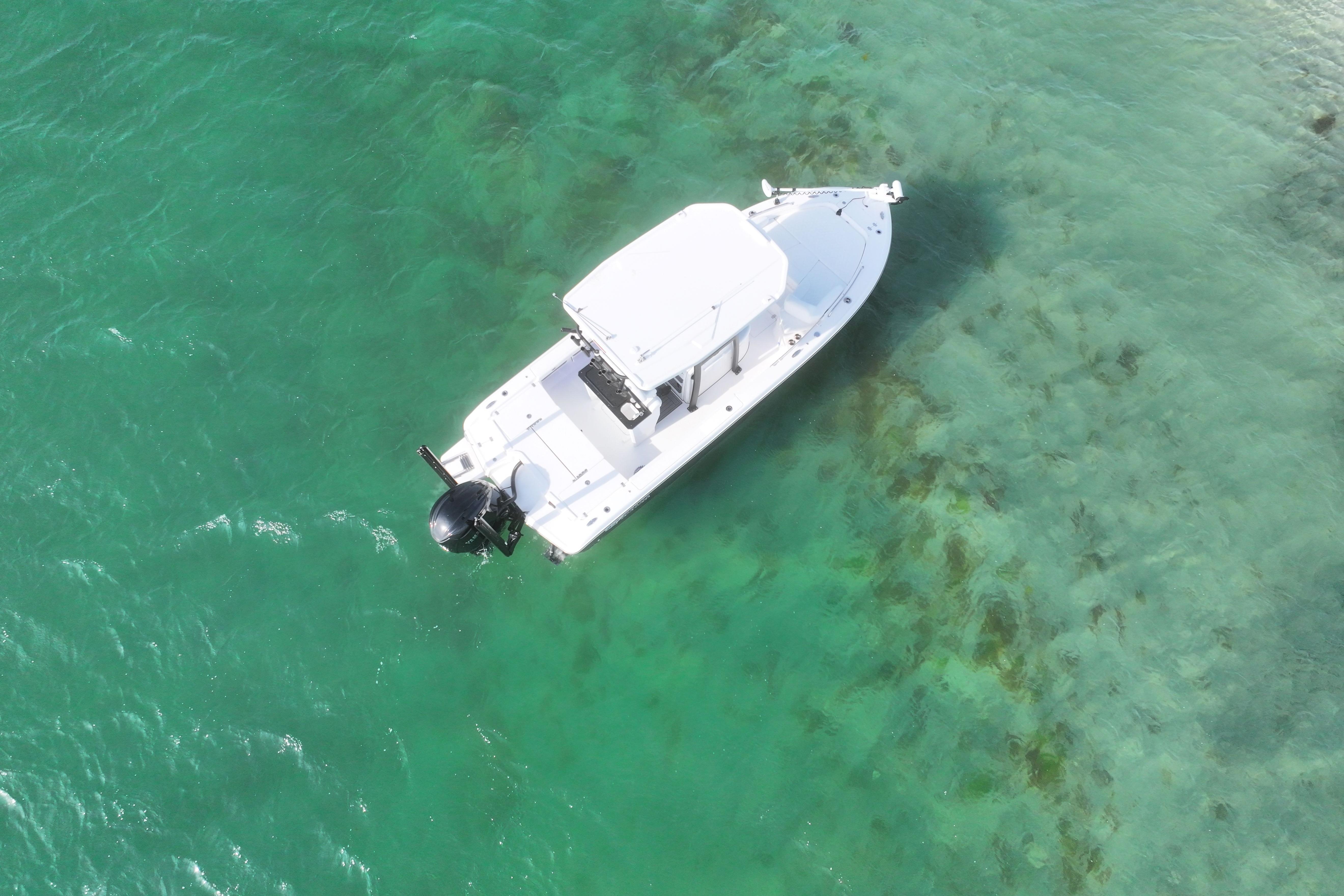 Aerial view of 2025 Crevalle 24 HCO boat on clear turquoise water.