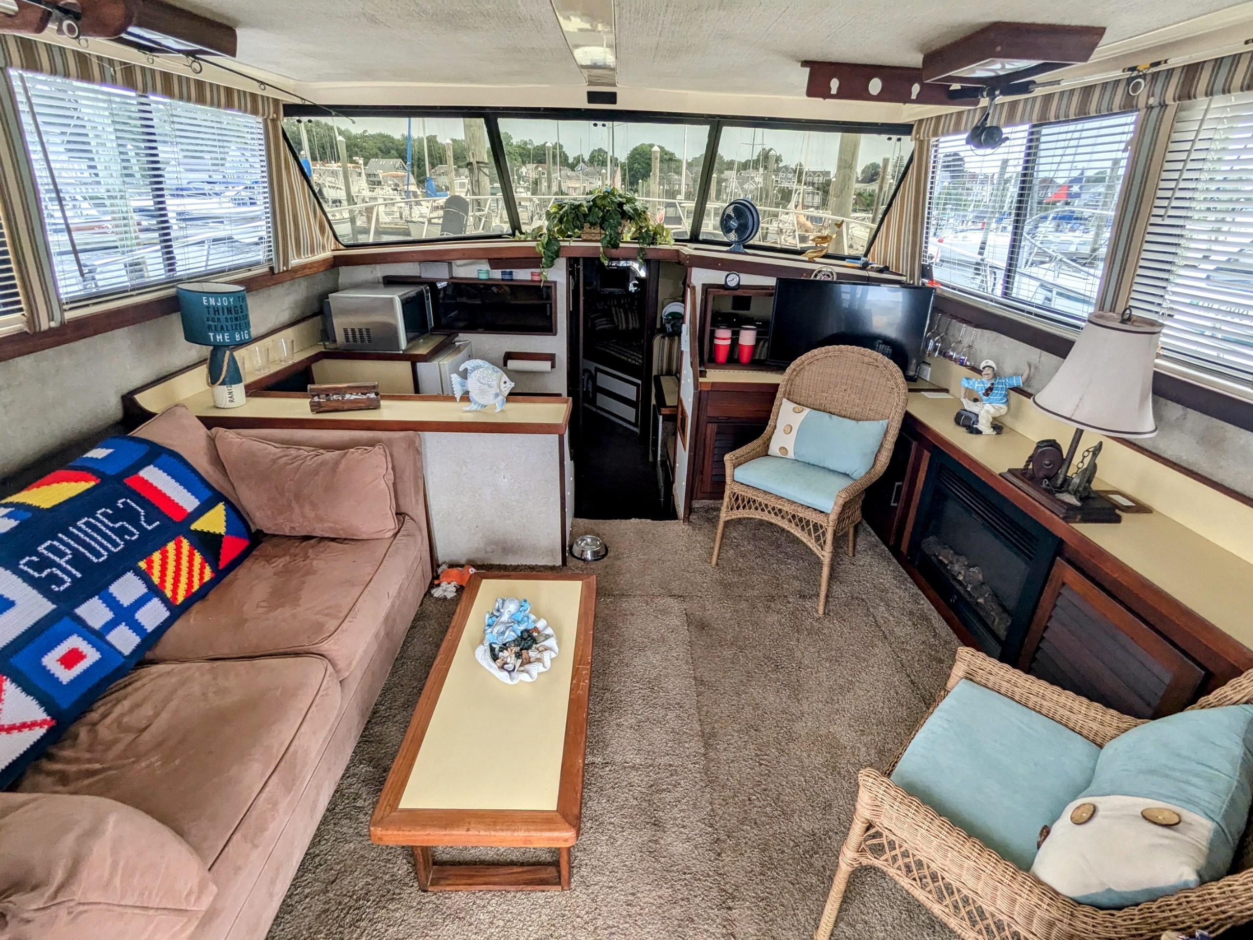 Interior of 1981 Silverton 37 Convertible yacht with cozy seating and nautical decor.