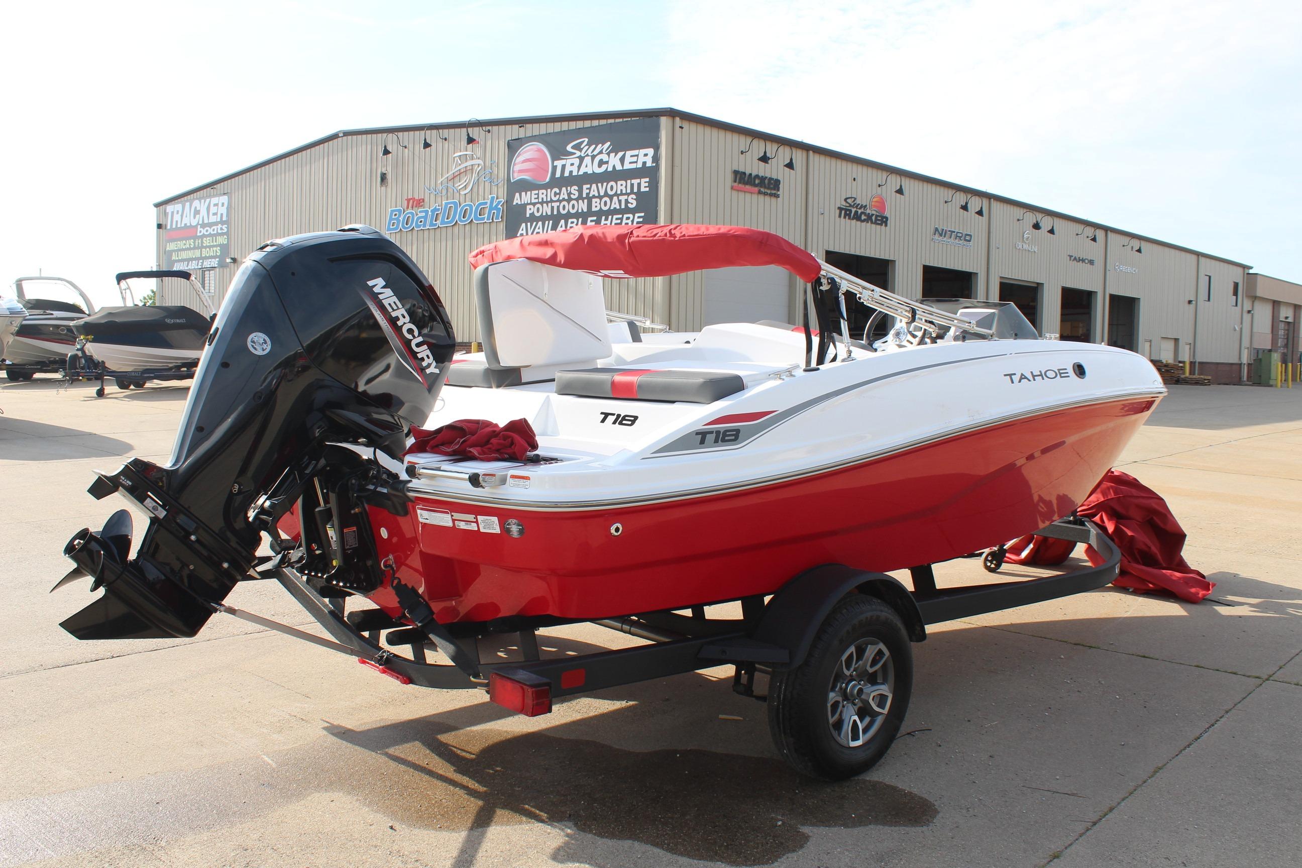 2026 Tahoe T18 boat with Mercury engine on trailer outside dealership.
