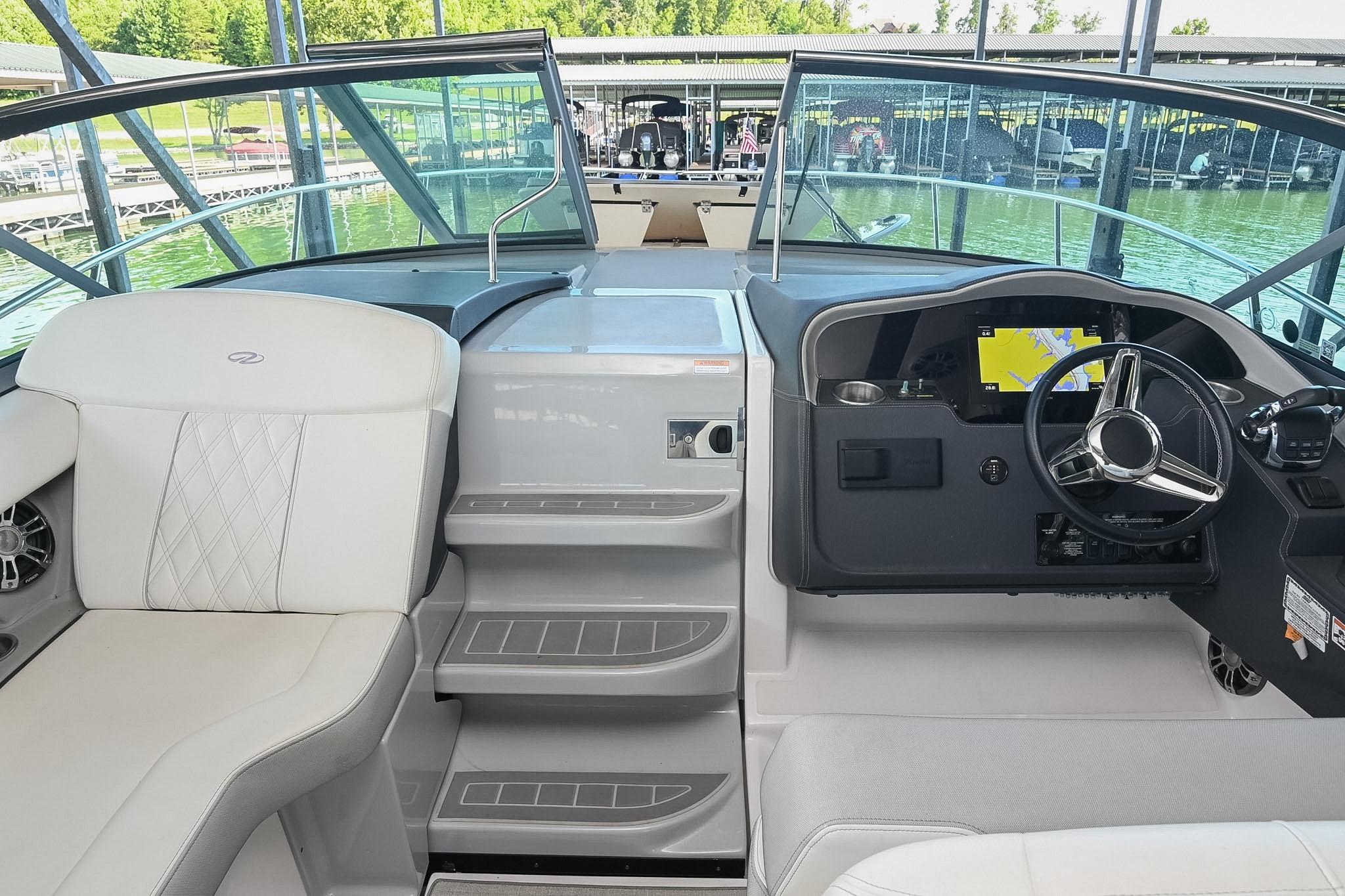 2021 Regal 33 Express boat cockpit with modern steering and navigation system.