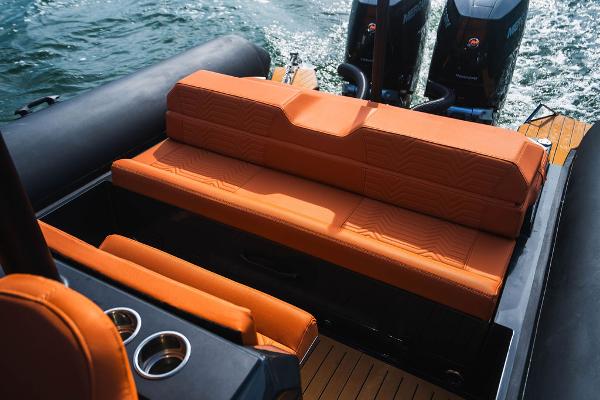 2024 Onda Magna boat with orange seating and dual outboard motors.