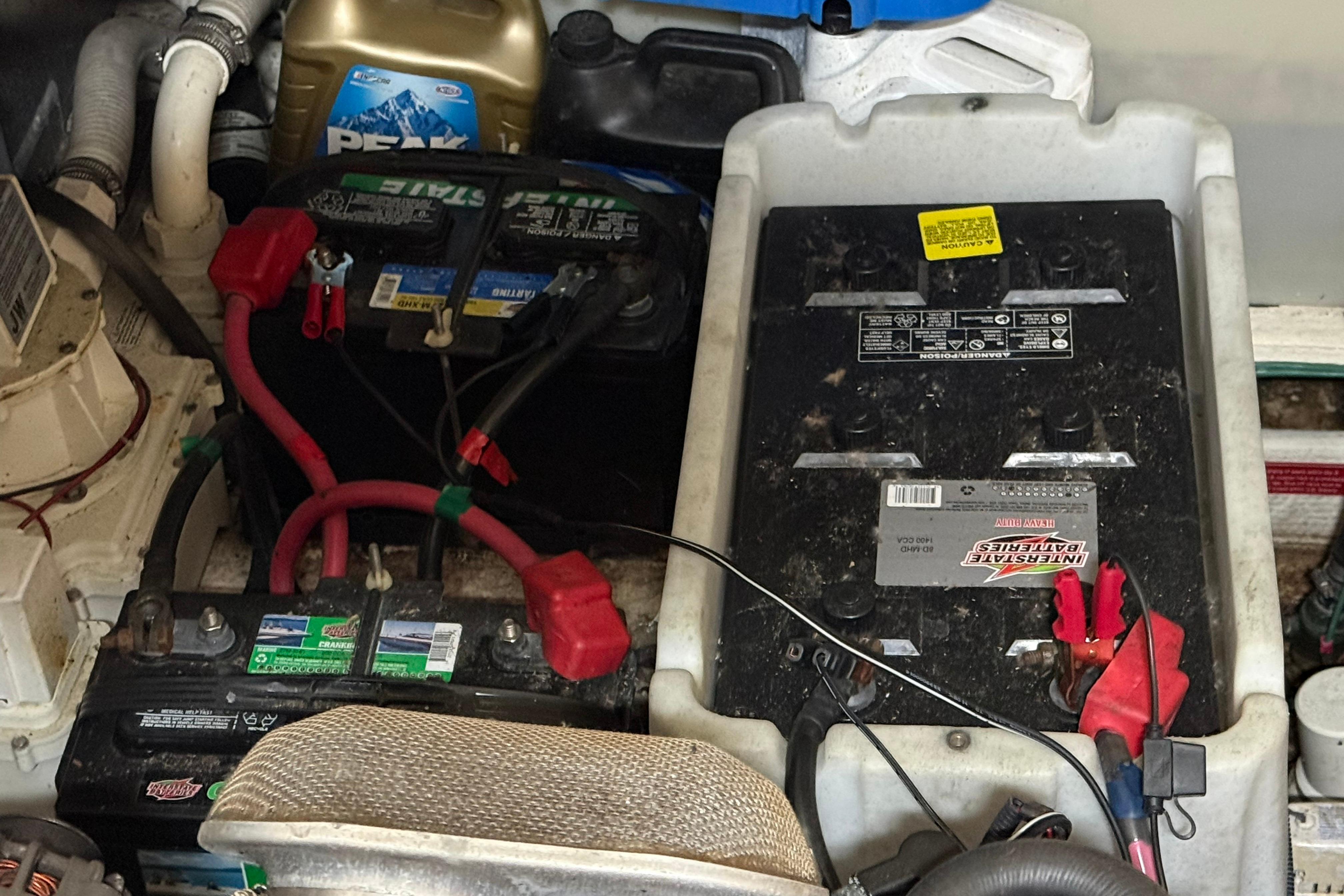 Engine compartment of 2007 Regal Commodore 3760 IO with batteries and coolant container.