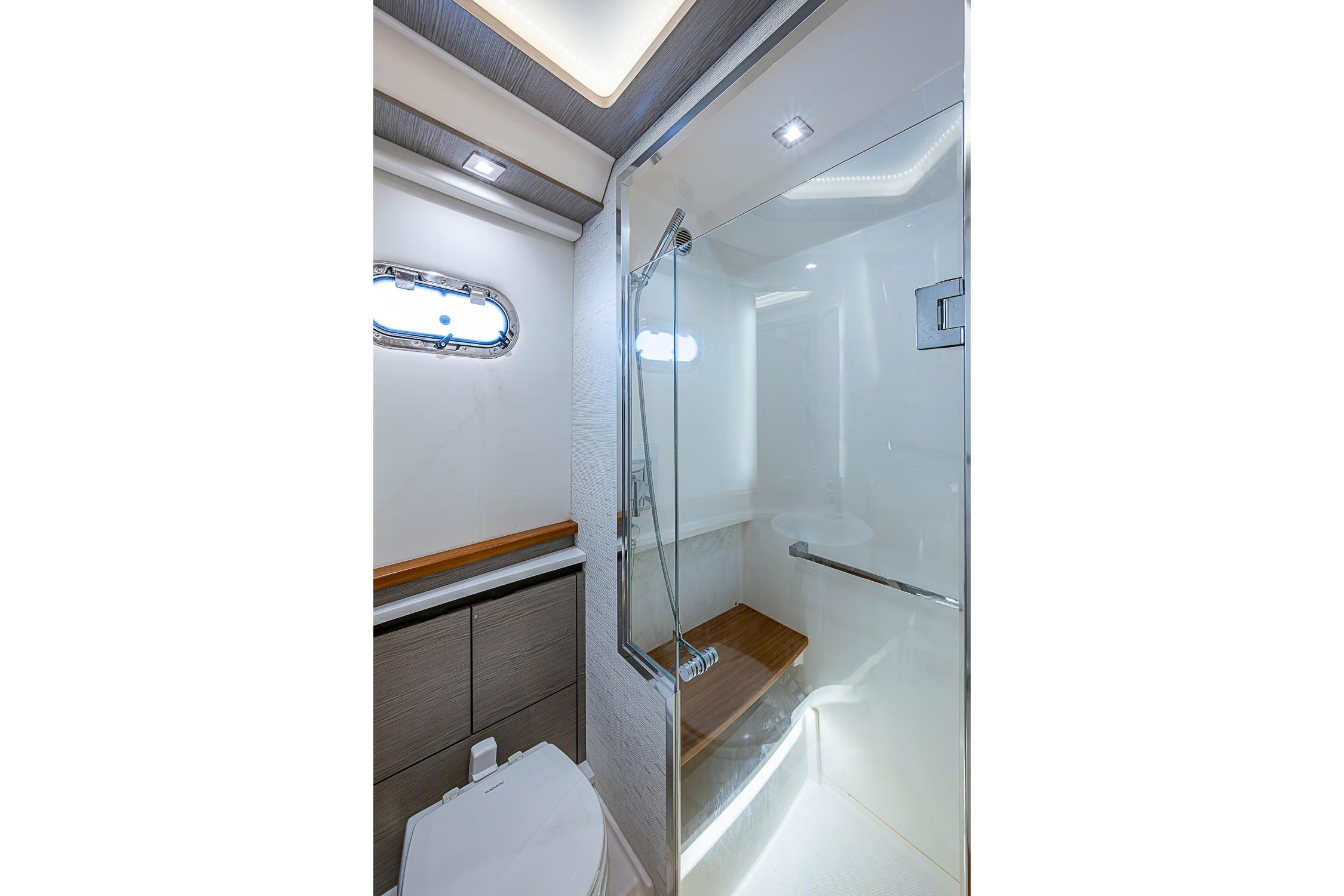 Luxurious bathroom in 2024 Tiara Yachts 48 LS, featuring modern shower and sleek design.