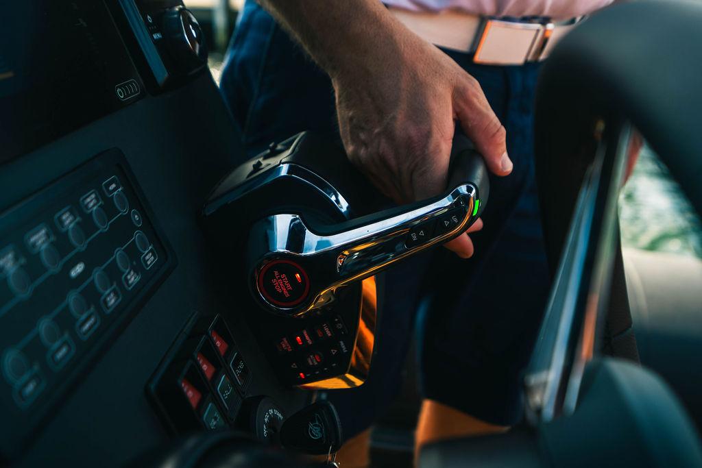 Hand operating controls on a 2025 Onda Magna boat dashboard.