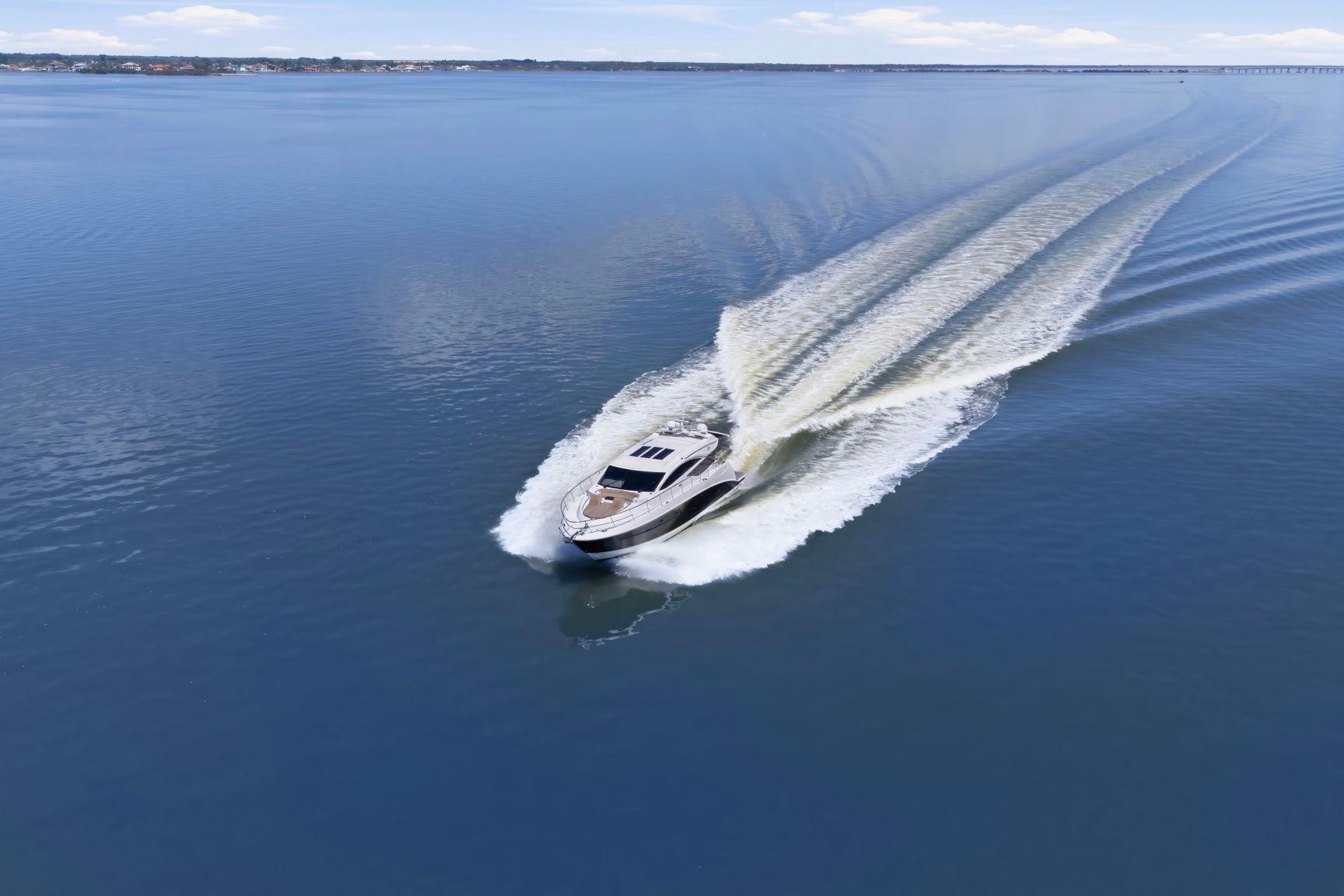 2017 Sea Ray L590 yacht cruising on calm blue waters, leaving a wake behind.