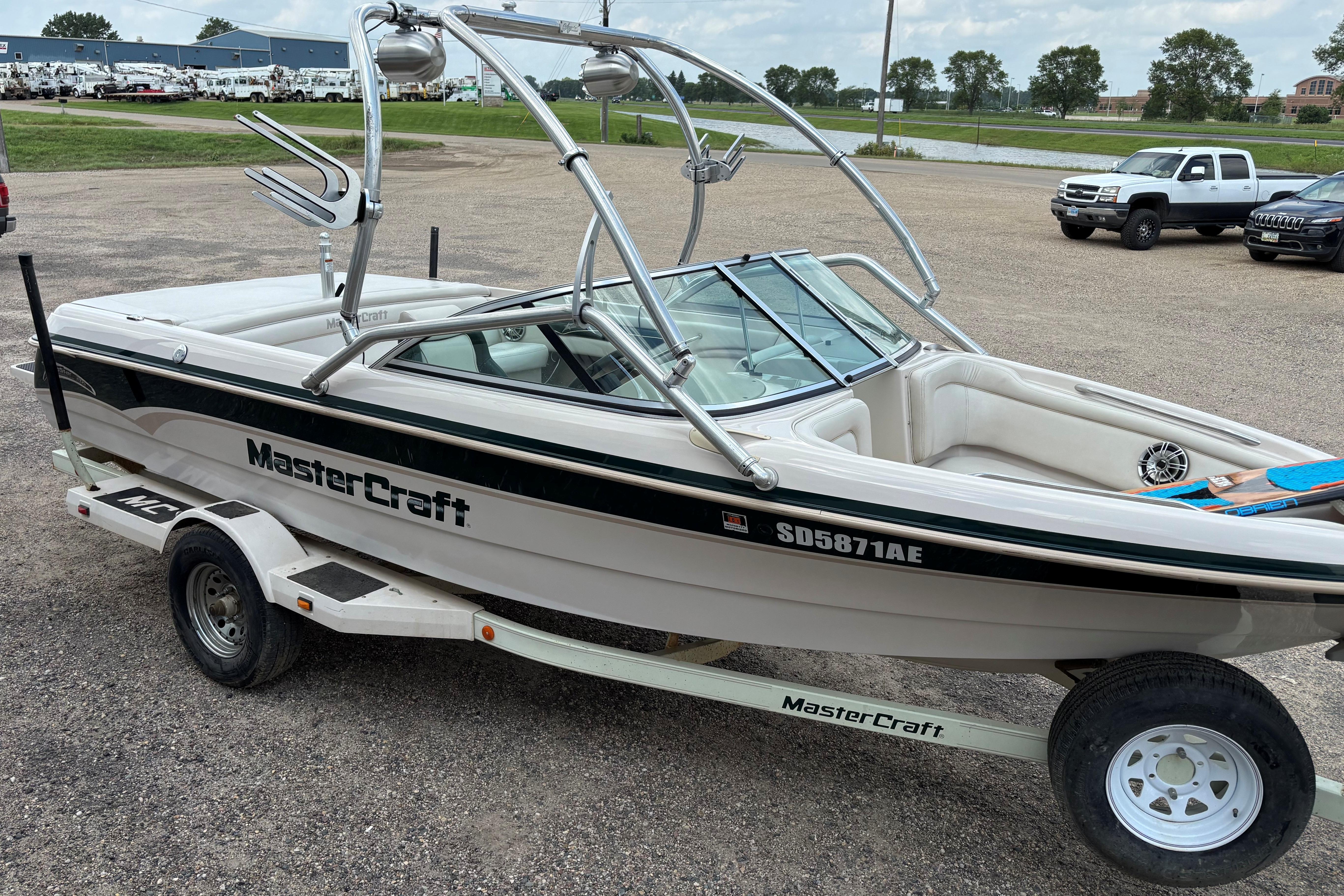 1999 MasterCraft 205 PRO STAR boat on trailer, parked outdoors.