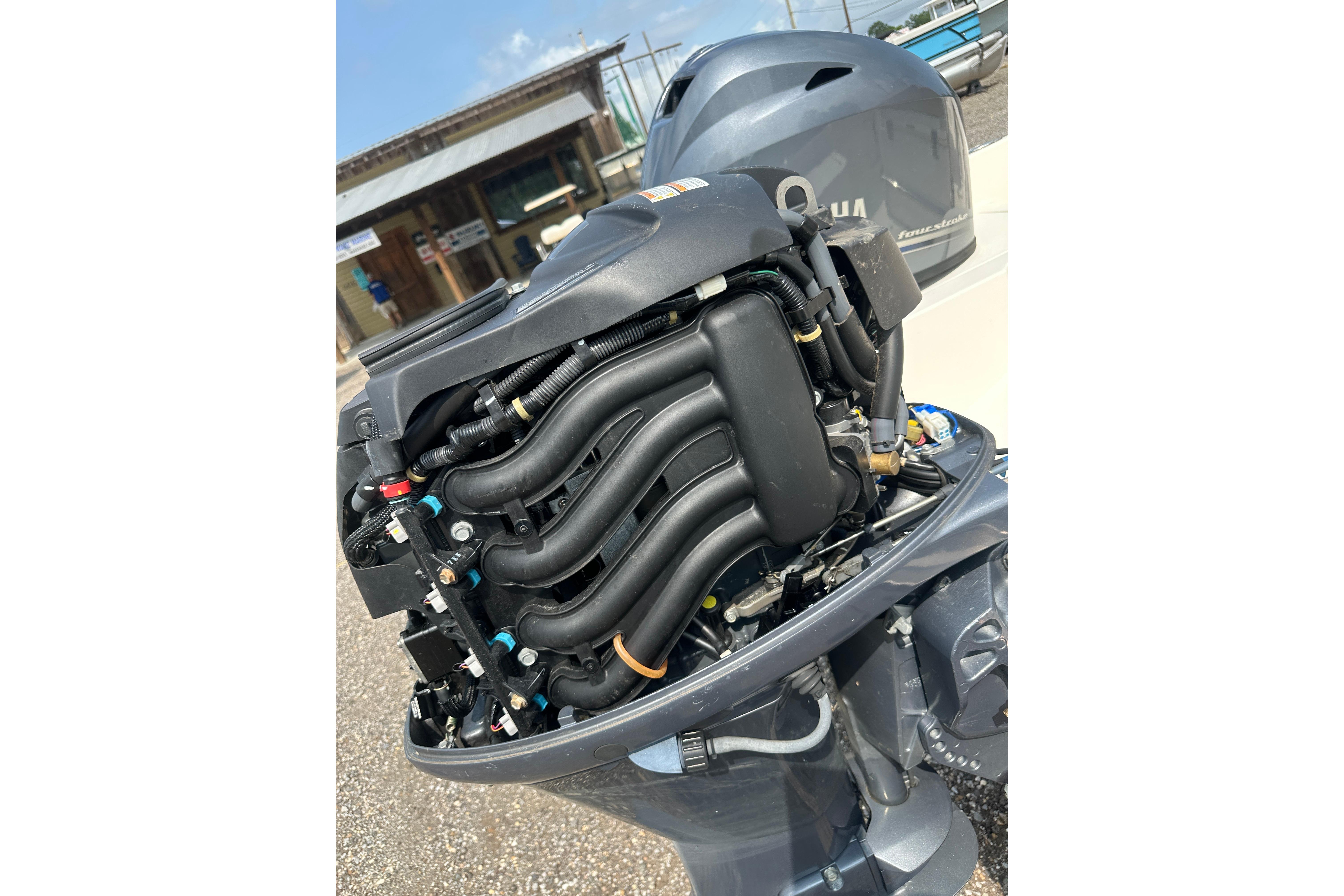 Open engine of a 2018 Key West 1720 Center Console boat, showcasing intricate components.