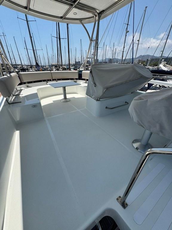 Flybridge of 2022 Rodman 1290 Evolution yacht with covered seating and table.