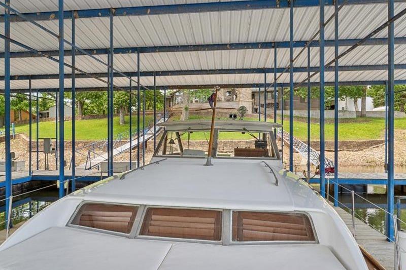 1964 Chris-Craft 37 Constellation docked under a covered marina.