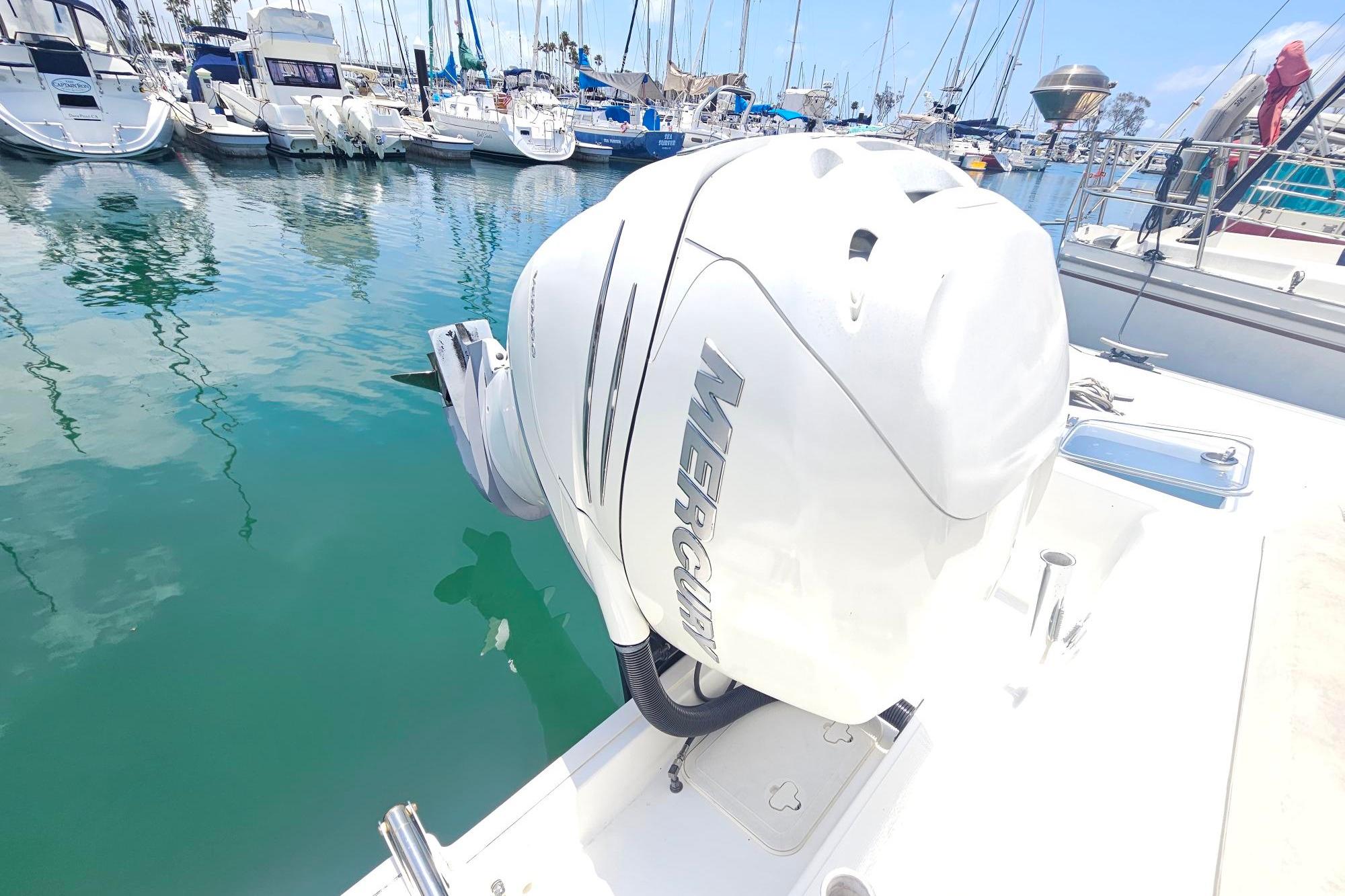 2017 Boston Whaler 230 Outrage with Mercury engine docked in marina.