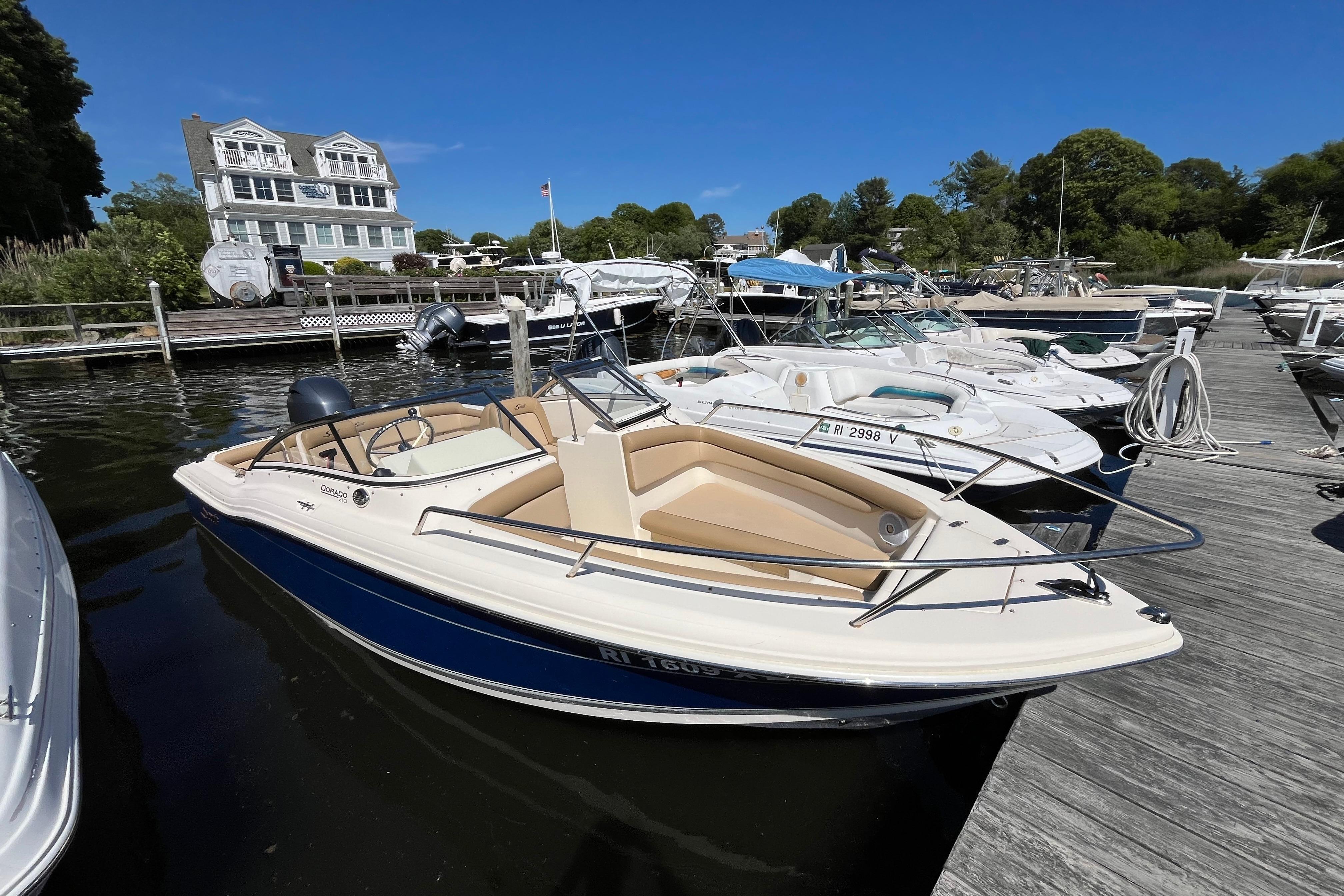 2017 Scout 210 Dorado boat docked at marina under clear blue sky.