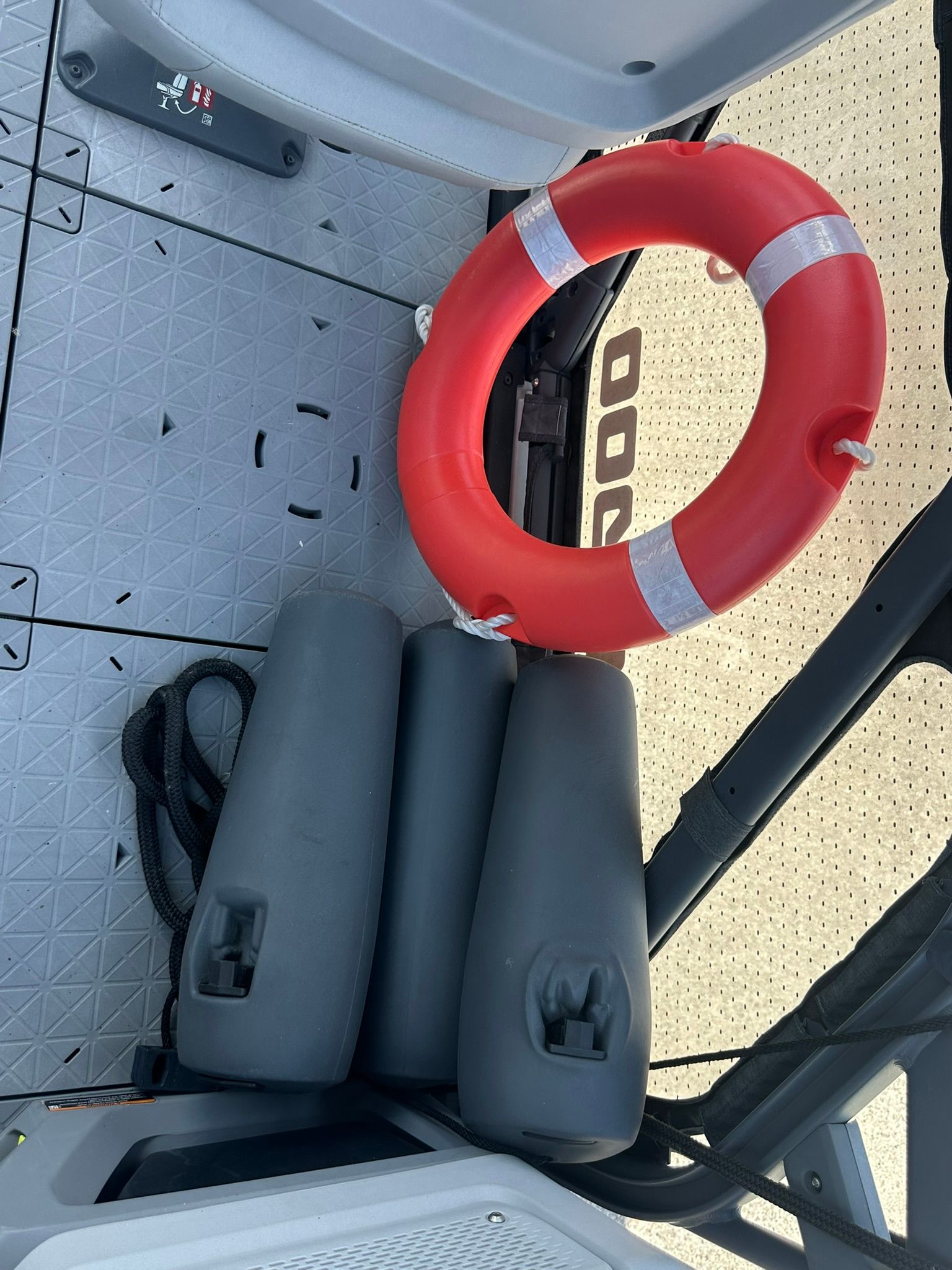 Lifebuoy and fenders on the floor of a Sea-Doo 21 SWITCH SPORT boat.