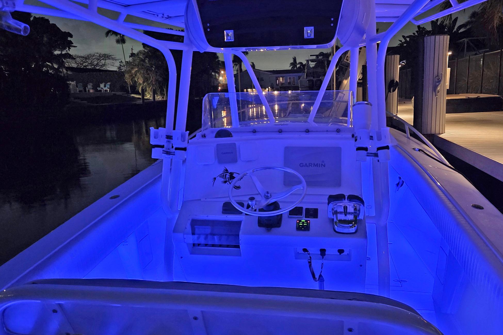 2001 Jupiter 31 Cuddy boat interior with blue LED lighting at night.