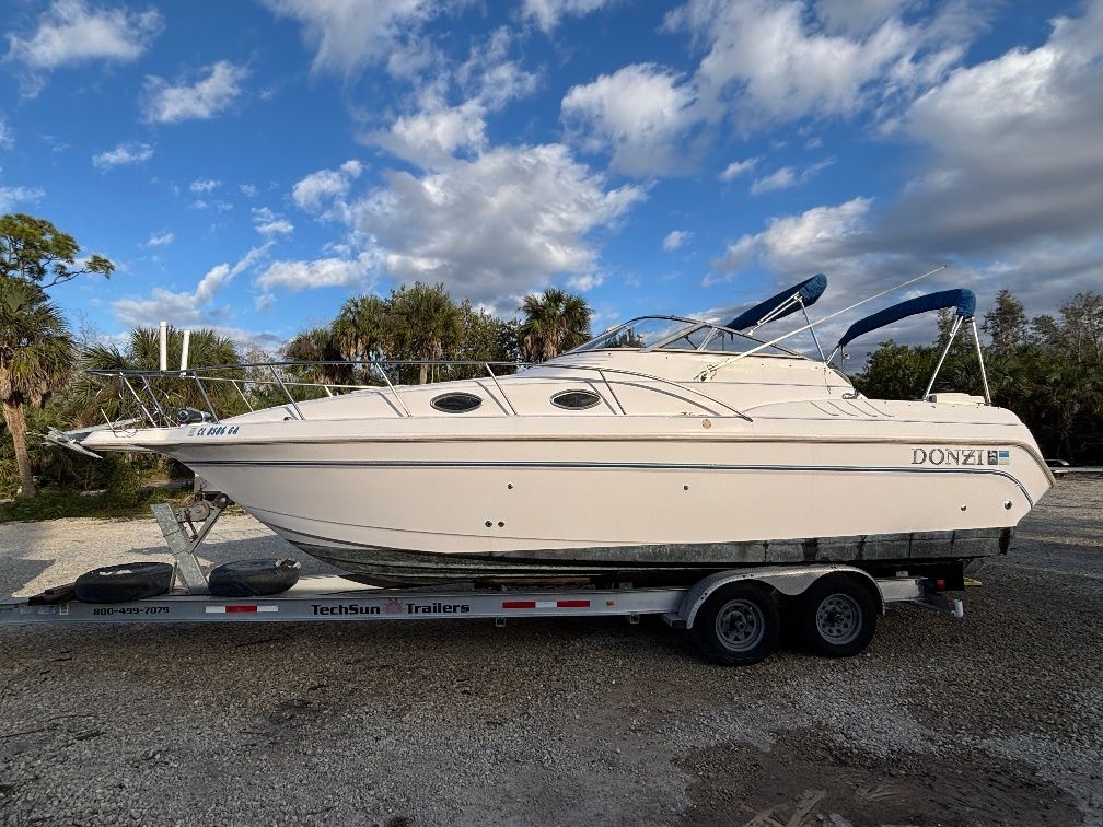 1997 Donzi 275LXC boat on trailer under blue sky.