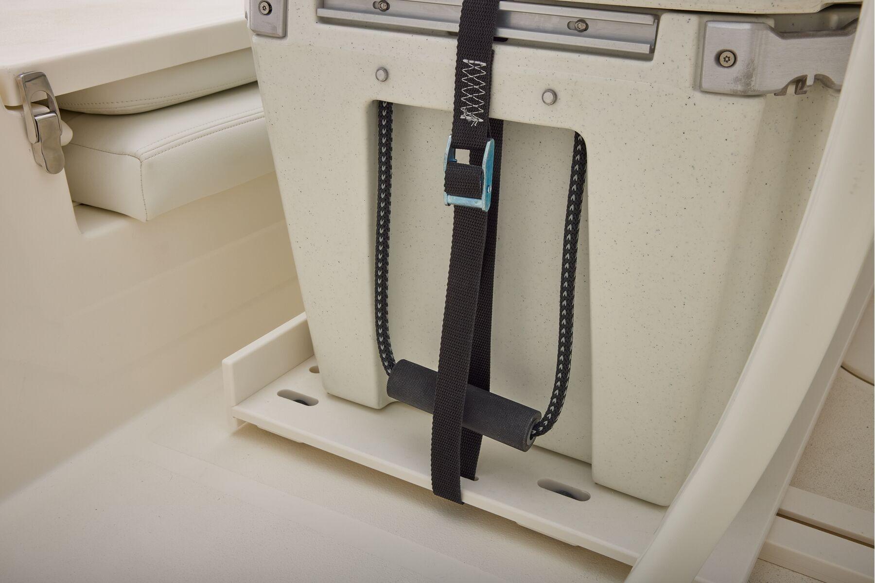 Secure storage compartment on 2026 Mako 24 APEX boat with strap and latch.
