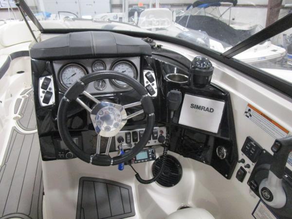 Cockpit of 2017 Larson 292 LXI boat with steering wheel and navigation instruments.