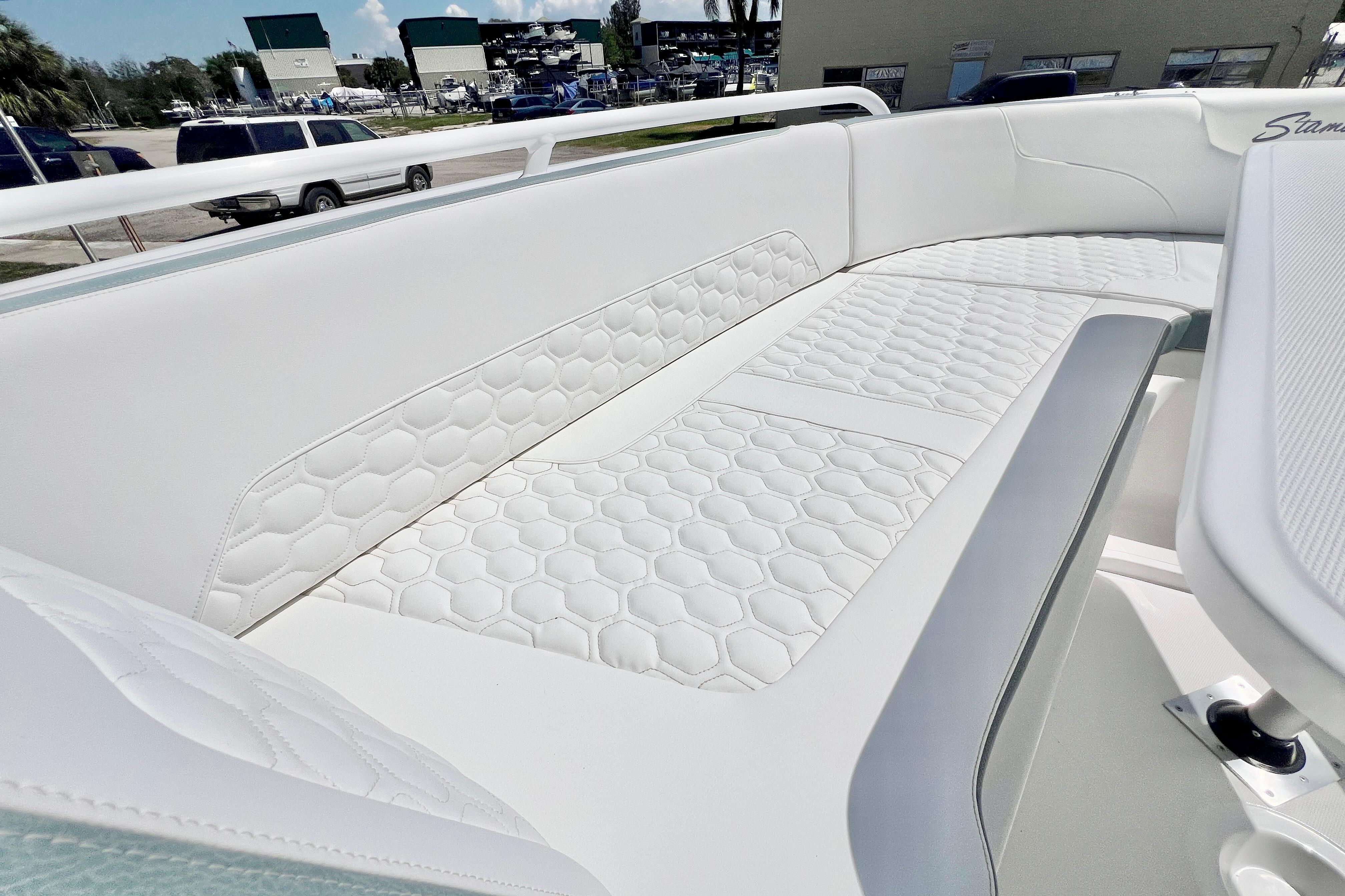 Luxurious seating on 2026 Stamas 31T Aventura boat with hexagonal pattern upholstery.