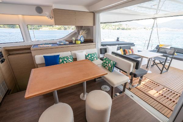 Interior of 2025 Lagoon 43 yacht with modern dining area and scenic ocean view.