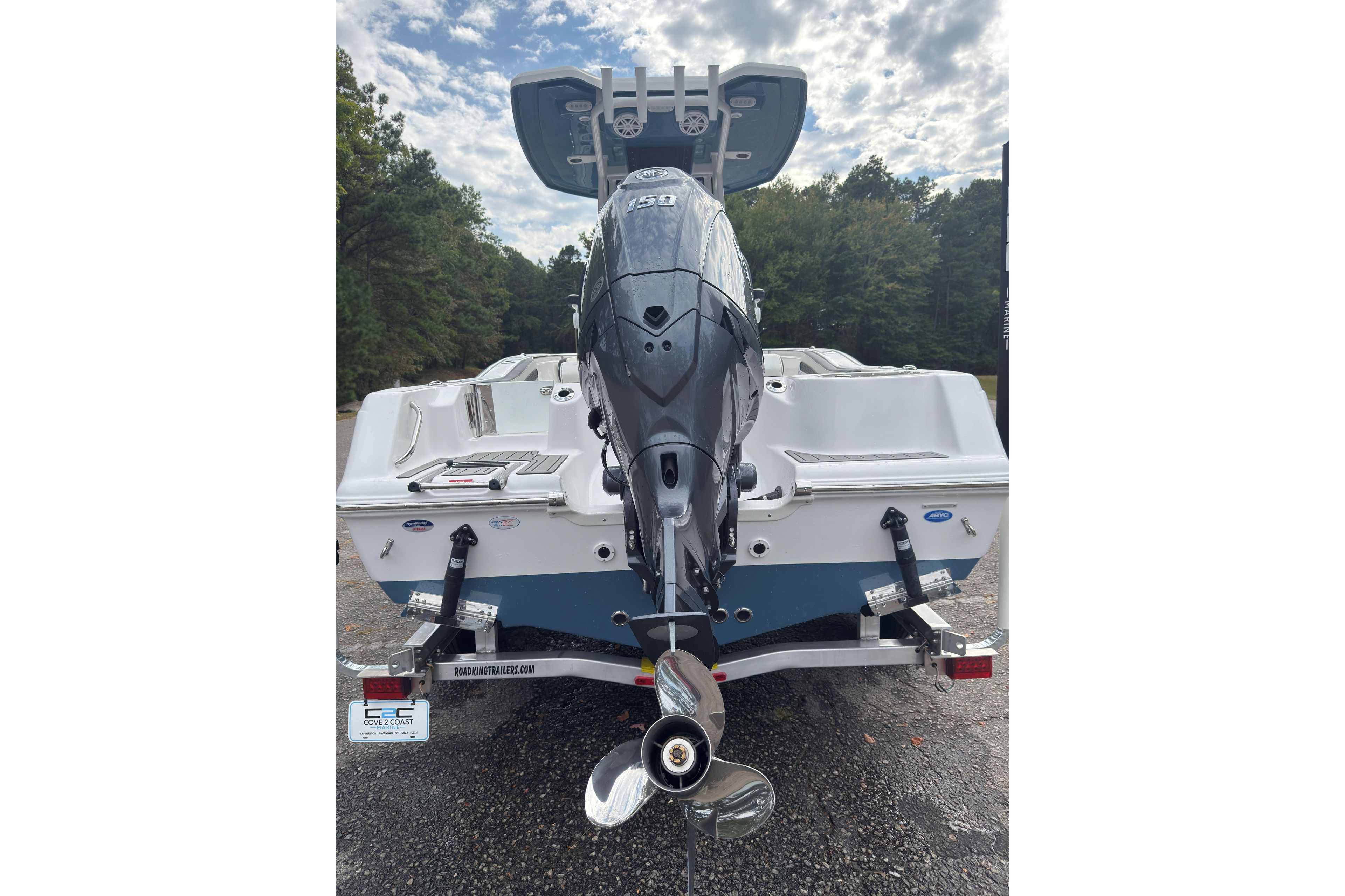 2026 Tidewater 210 CC Adventure boat with powerful outboard motor, parked outdoors.