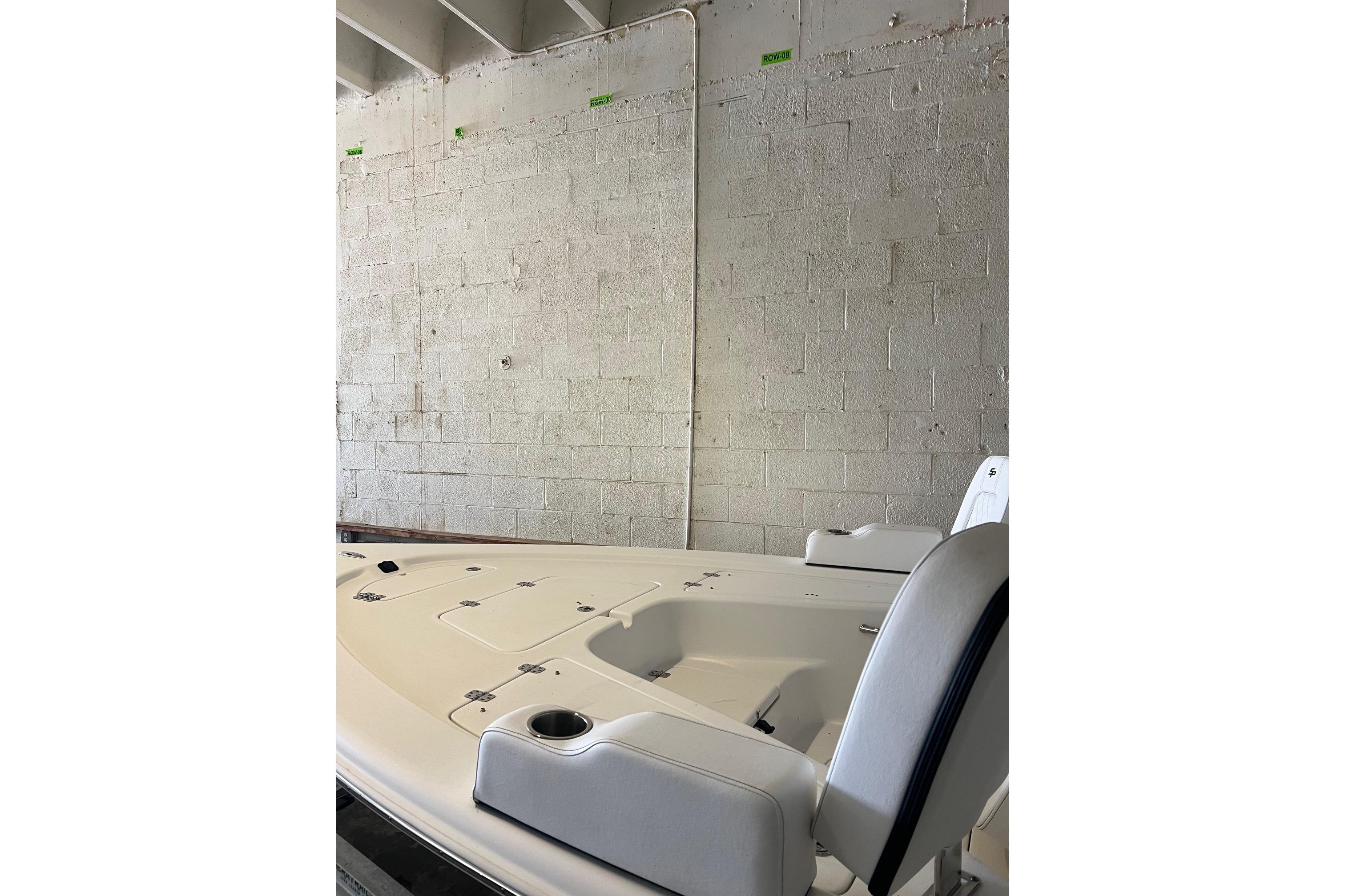 2024 Sea Pro 230 Bay boat interior, featuring seating and storage compartments.