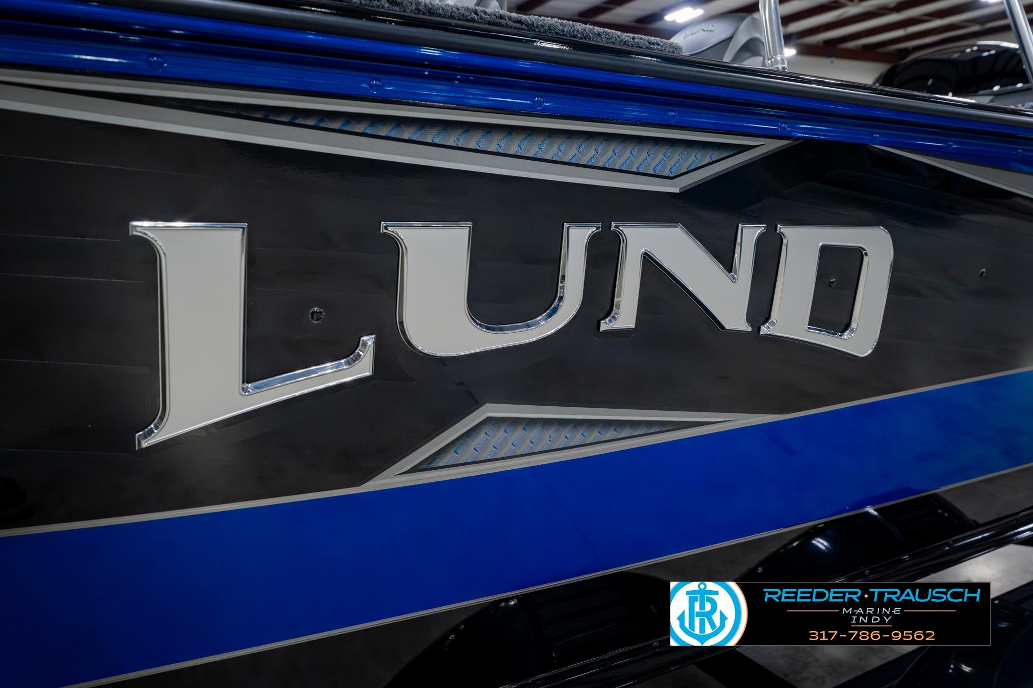 2026 Lund 1875 Impact XS boat with sleek blue and black design.